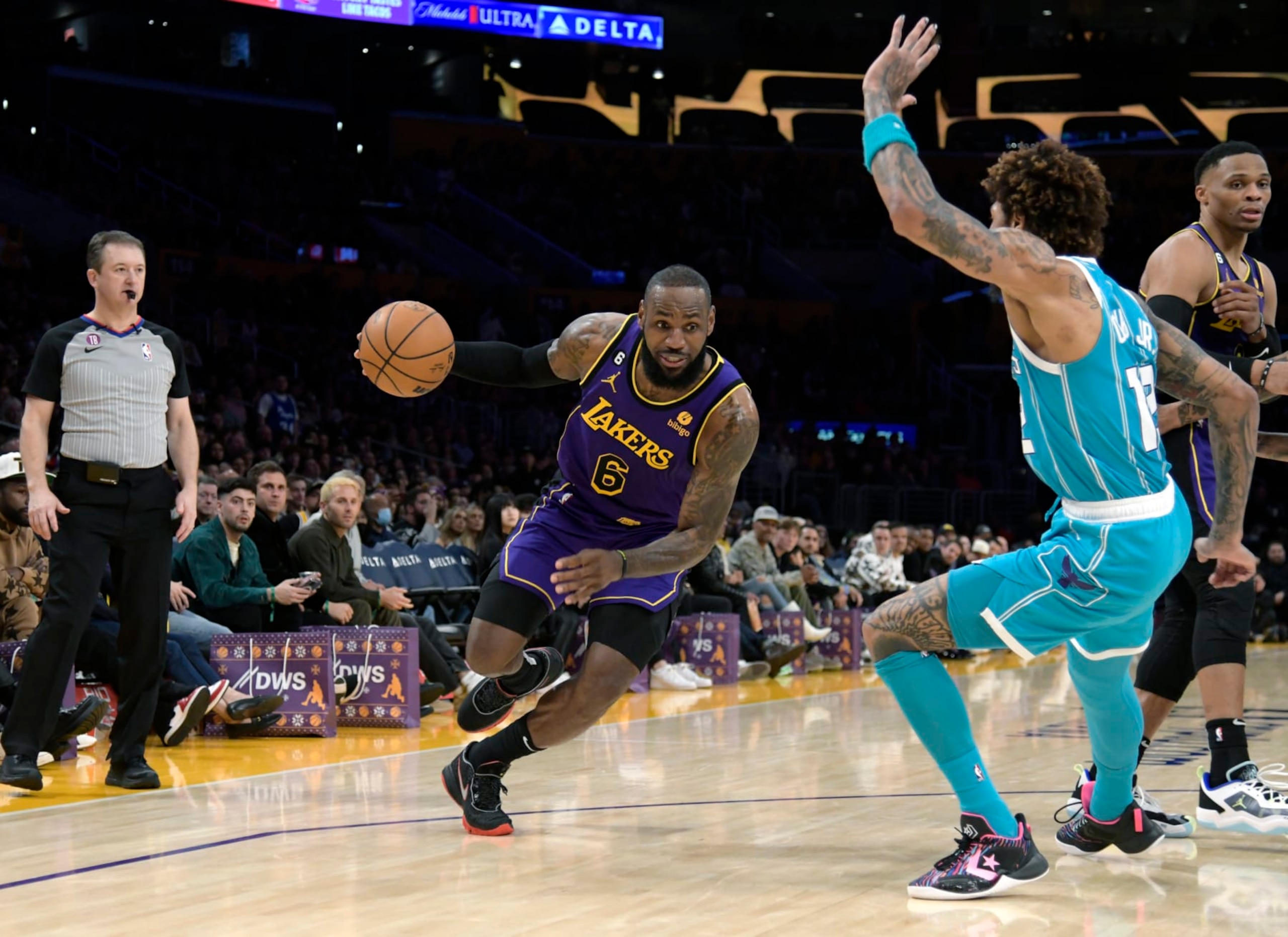 LOS ANGELES, CA - DECEMBER 23: LeBron James #6 of the Los Angeles Lakers drives against Kelly Oubre Jr. #12 of the Charlotte Hornets during the second half  at Crypto.com Arena on December 23, 2022 in Los Angeles, California. NOTE TO USER: User expressly acknowledges and agrees that, by downloading and or using this photograph, User is consenting to the terms and conditions of the Getty Images License Agreement. (Photo by Kevork Djansezian/Getty Images)