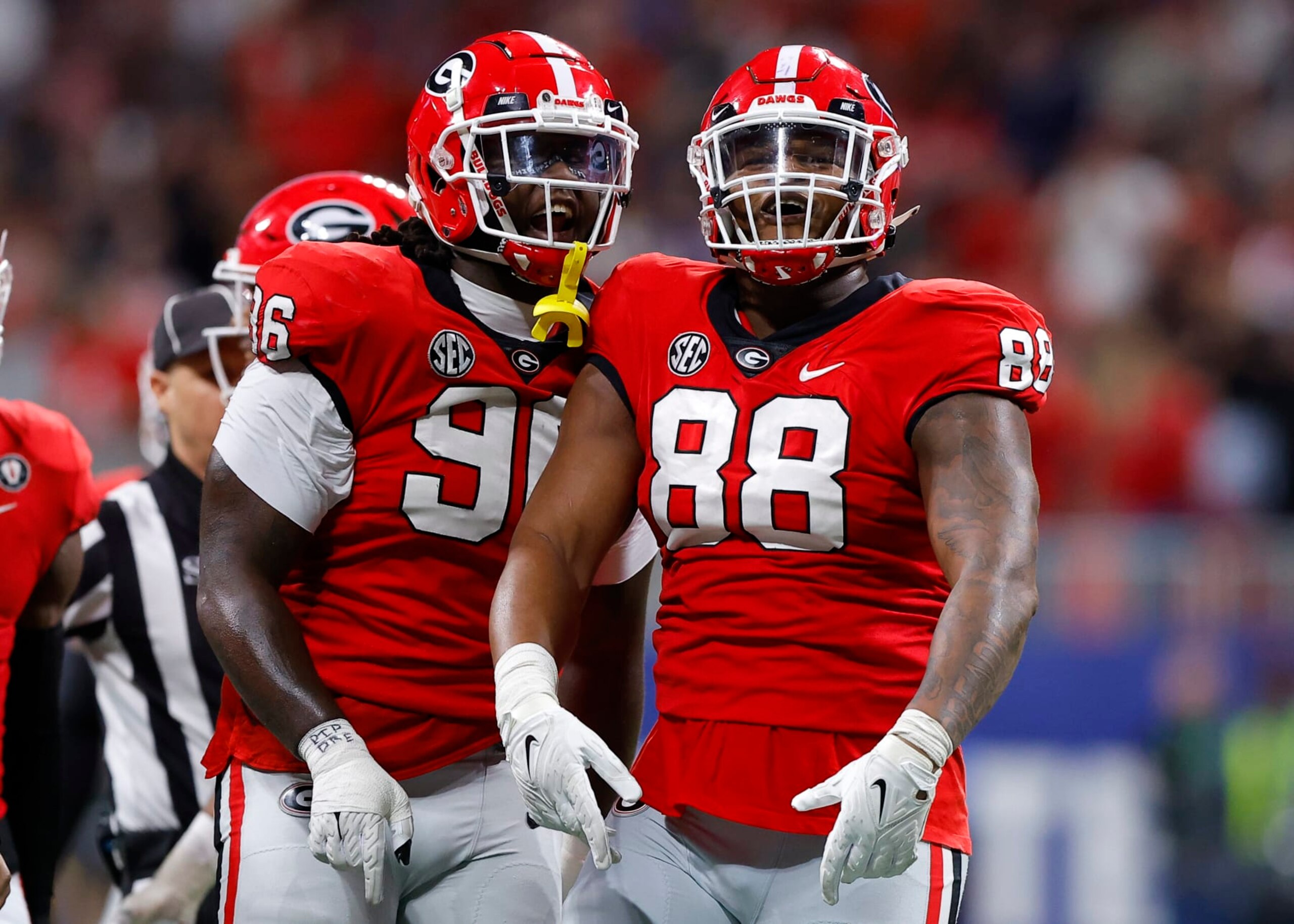 ATLANTA, GA - DECEMBER 03: Zion Logue #96 and Jalen Carter #88 of the Georgia Bulldogs reacts after a stop against the LSU Tigers during the first half of the SEC Championship game at Mercedes-Benz Stadium on December 3, 2022 in Atlanta, Georgia. (Photo by Todd Kirkland/Getty Images)