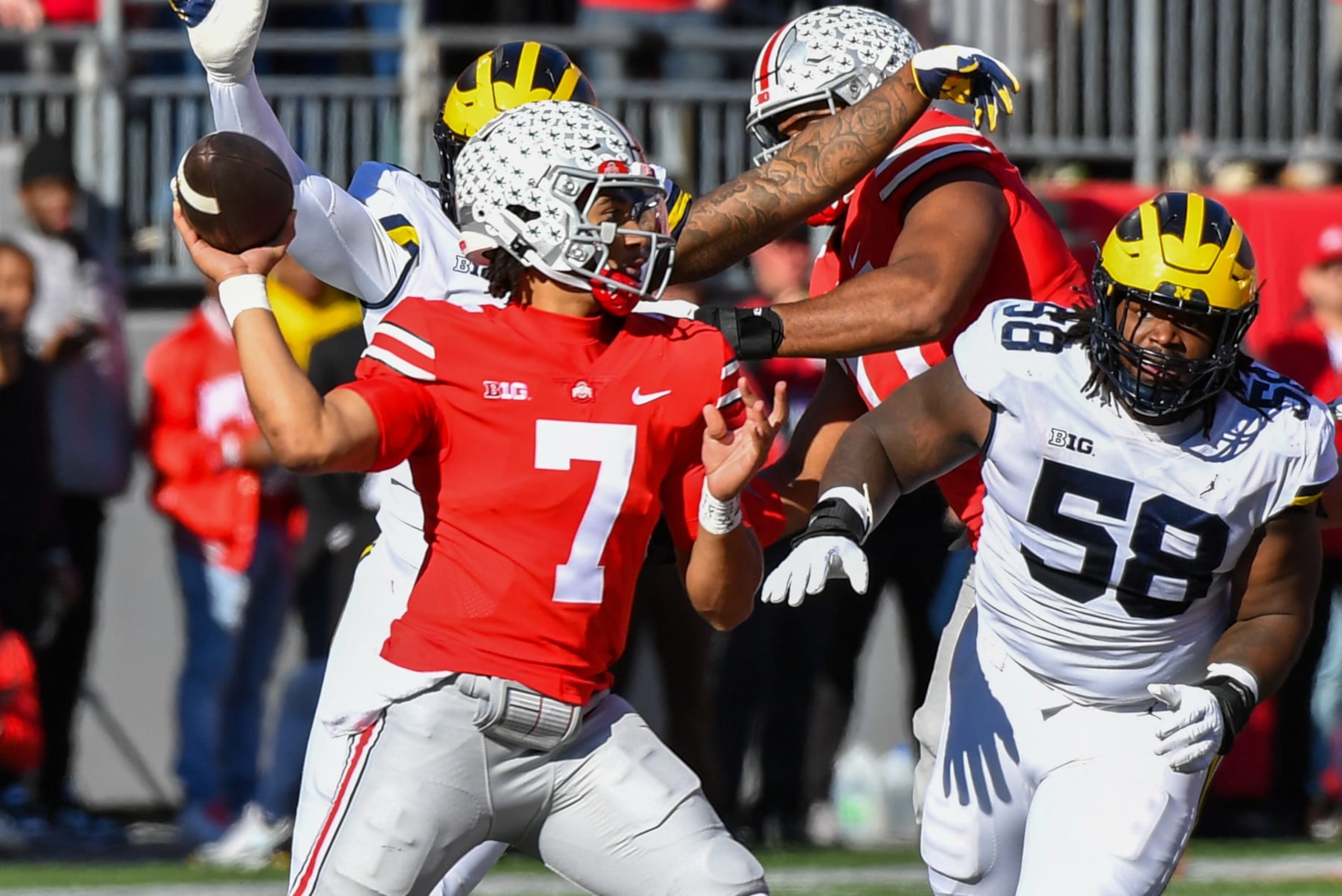 COLUMBUS, OHIO - NOVEMBER 26: C.J. Stroud #7 of the Ohio State Buckeyes attempts to throw a pass as Mazi Smith #58 of the Michigan Wolverines closes in during the first half of a college football game at Ohio Stadium on November 26, 2022 in Columbus, Ohio. (Photo by Aaron J. Thornton/Getty Images)