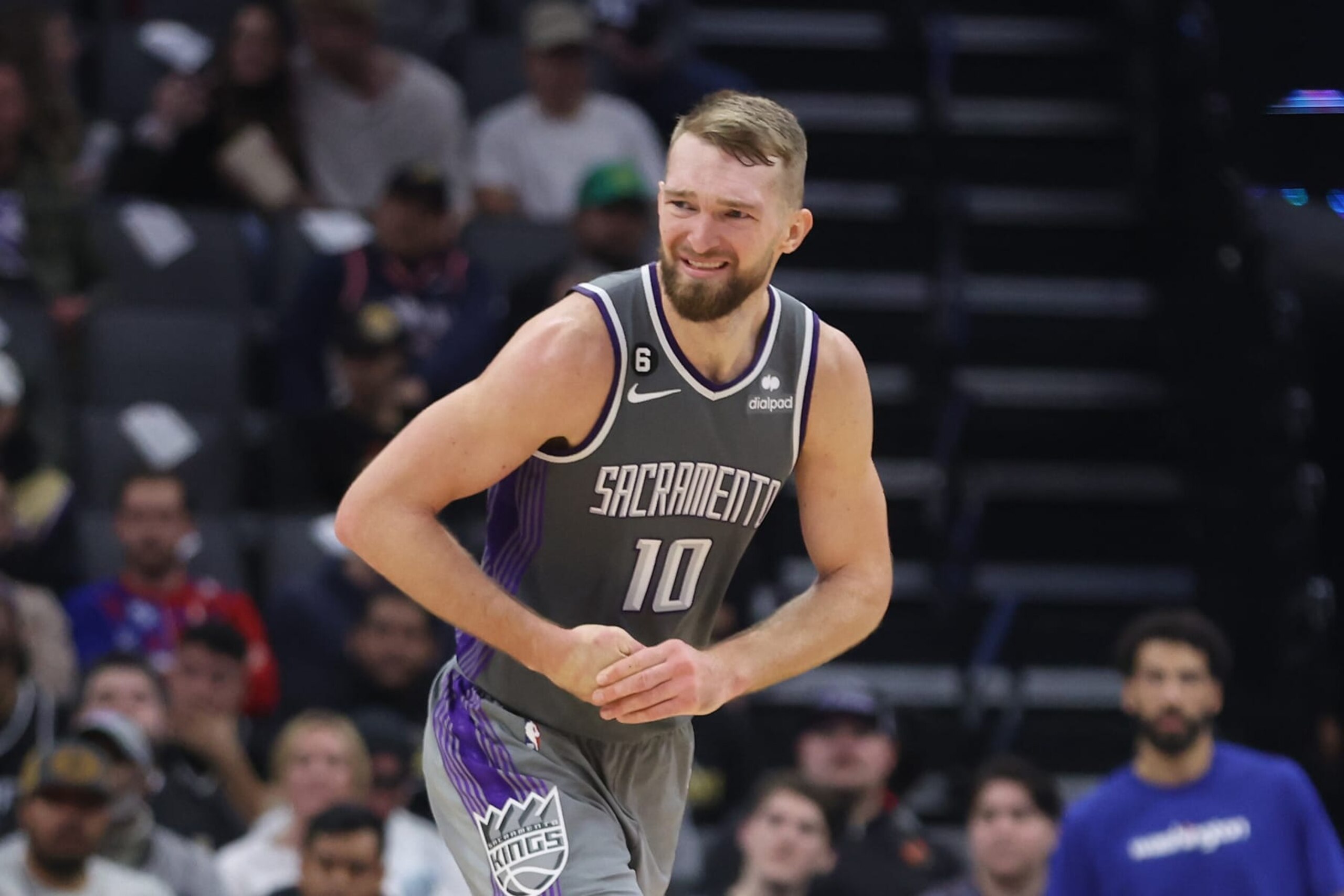 SACRAMENTO, CALIFORNIA - DECEMBER 23: Domantas Sabonis #10 of the Sacramento Kings grimaces as he holds his hand in the fourth quarter against the Washington Wizards at Golden 1 Center on December 23, 2022 in Sacramento, California. NOTE TO USER: User expressly acknowledges and agrees that, by downloading and/or using this photograph, User is consenting to the terms and conditions of the Getty Images License Agreement. (Photo by Lachlan Cunningham/Getty Images)