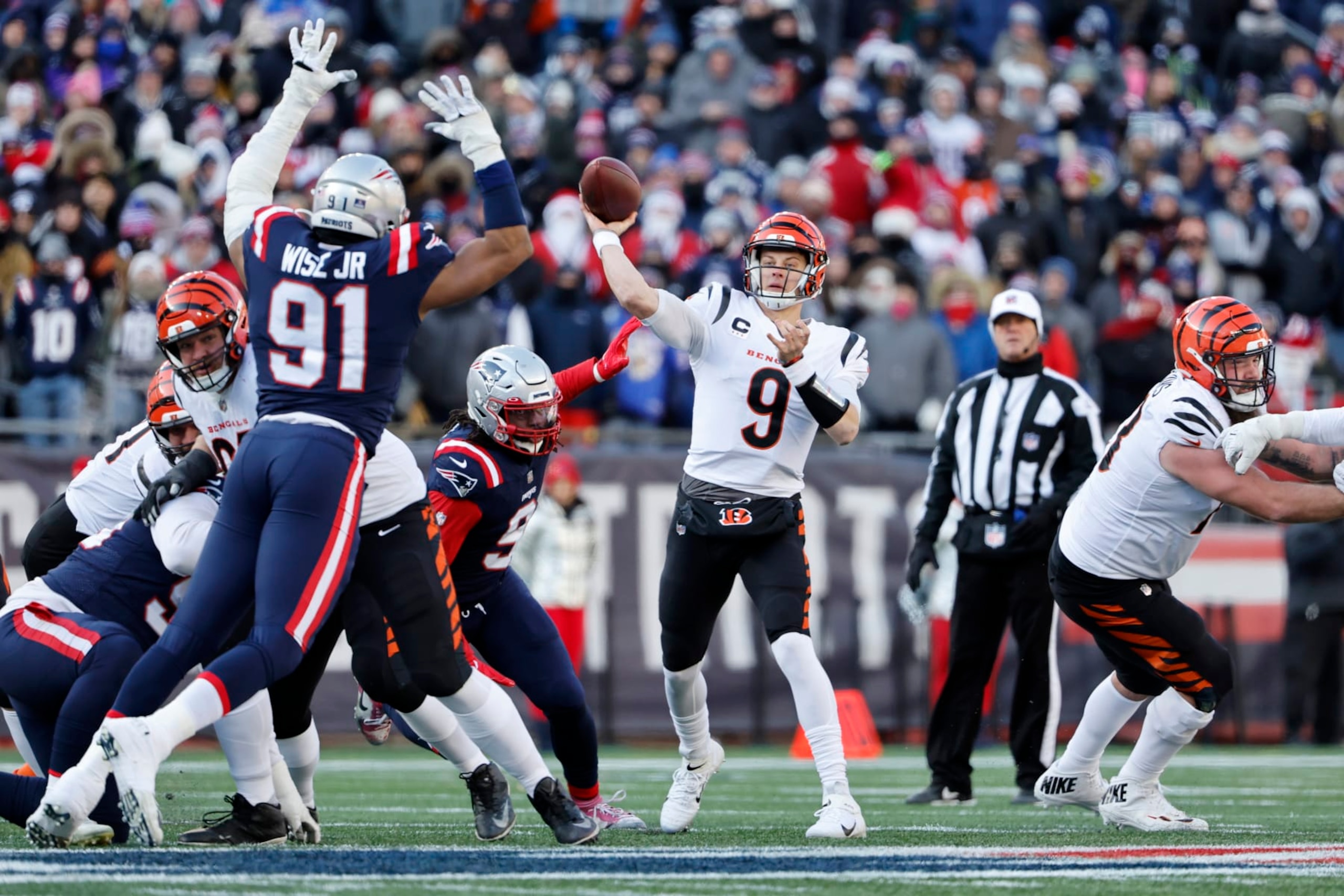 FOXBOROUGH, MASSACHUSETTS - DECEMBER 24: Joe Burrow #9 of the Cincinnati Bengals attempts a pass during the first quarter against the New England Patriots at Gillette Stadium on December 24, 2022 in Foxborough, Massachusetts. (Photo by Winslow Townson/Getty Images) FOXBOROUGH, MASSACHUSETTS - DECEMBER 24: Joe Burrow #9 of the Cincinnati Bengals attempts a pass during the first quarter against the New England Patriots at Gillette Stadium on December 24, 2022 in Foxborough, Massachusetts. (Photo by Winslow Townson/Getty Images)
