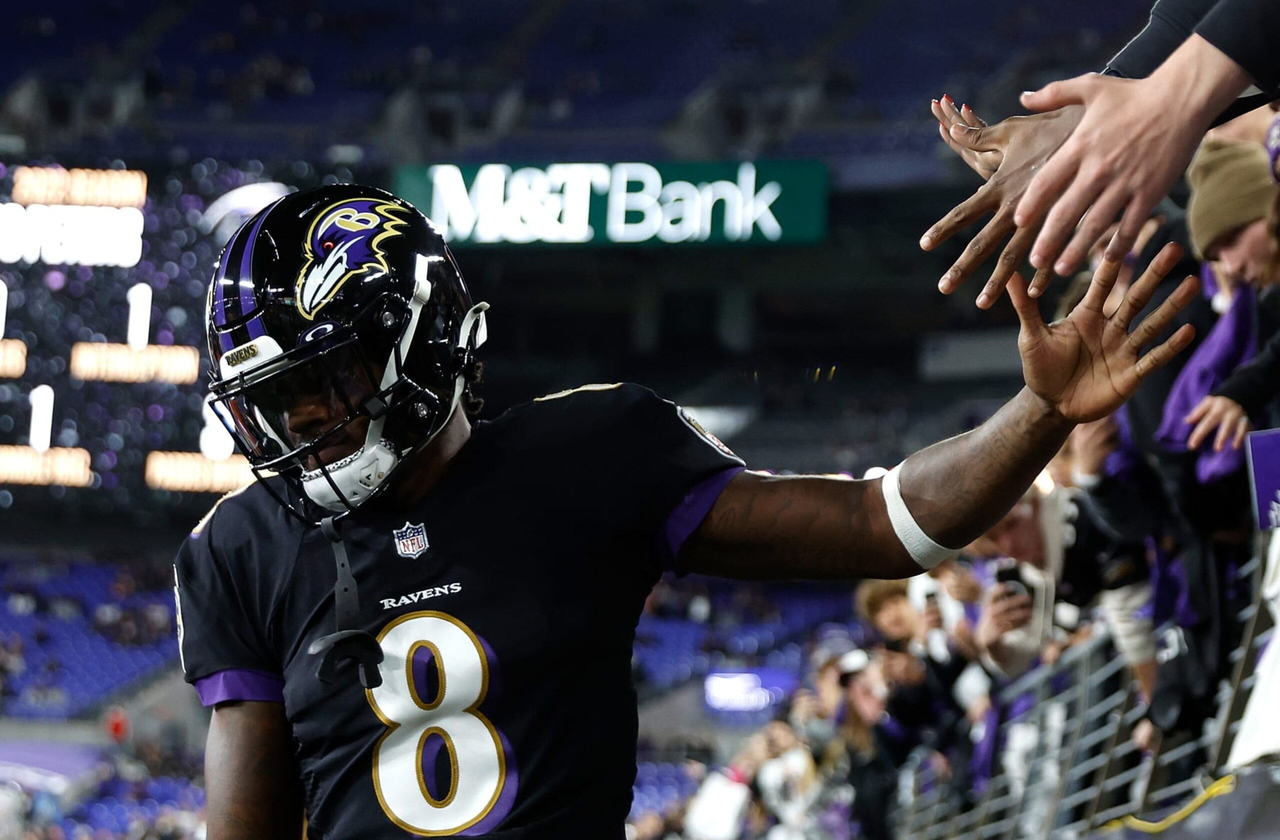 BALTIMORE, MARYLAND - OCTOBER 09:  Lamar Jackson #8 of the Baltimore Ravens acknowledges fans during pregame warmups prior to facing the Cincinnati Bengals at M&T Bank Stadium on October 09, 2022 in Baltimore, Maryland. (Photo by Tasos Katopodis/Getty Images)