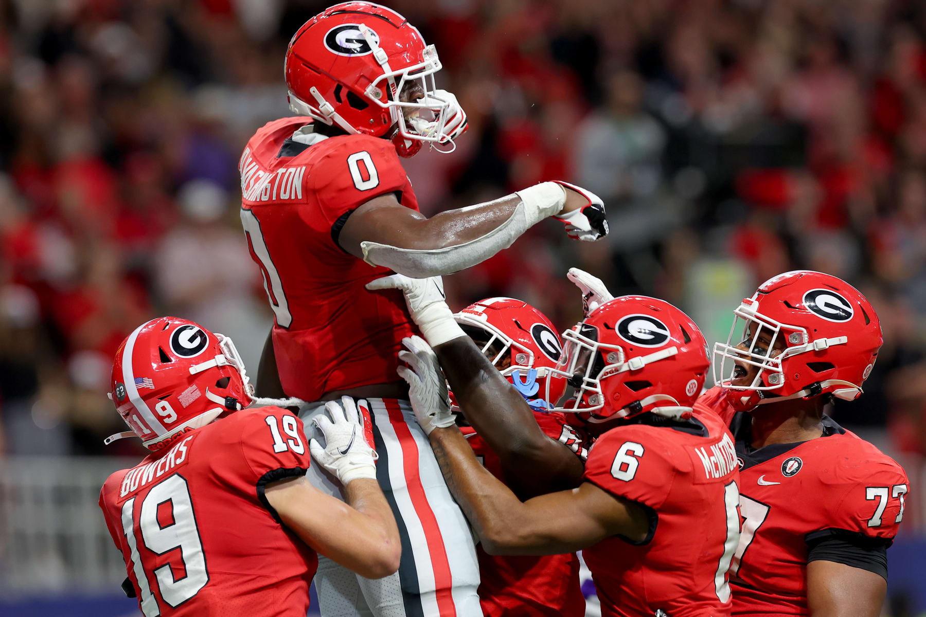 ATLANTA, GEORGIA - DECEMBER 03: Darnell Washington #0 of the Georgia Bulldogs celebrates with his teammates after scoring a touchdown against the LSU Tigers during the second quarter in the SEC Championship game at Mercedes-Benz Stadium on December 03, 2022 in Atlanta, Georgia. (Photo by Kevin C. Cox/Getty Images)