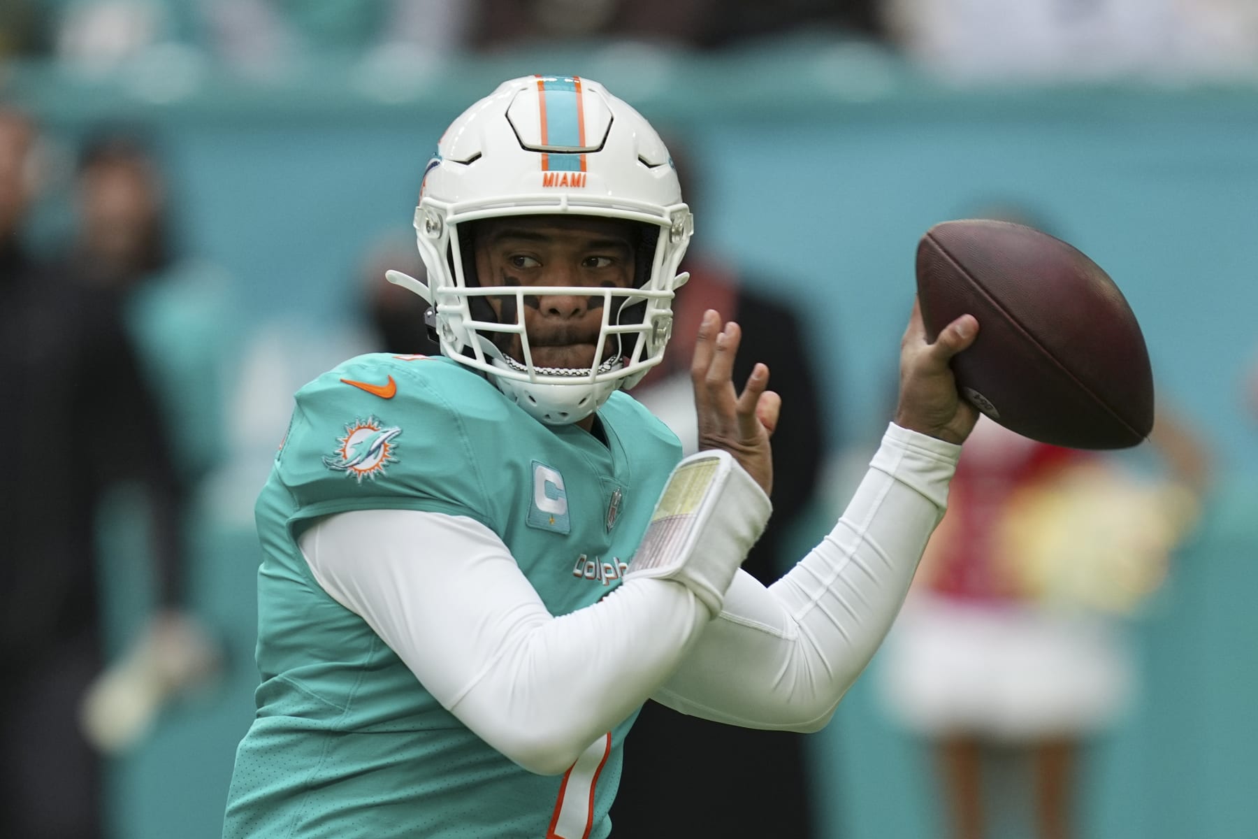 Miami Dolphins quarterback Tua Tagovailoa (1) looks to pass during the first half of an NFL football game against the Green Bay Packers, Sunday, Dec. 25, 2022, in Miami Gardens, Fla. (AP Photo/Jim Rassol)