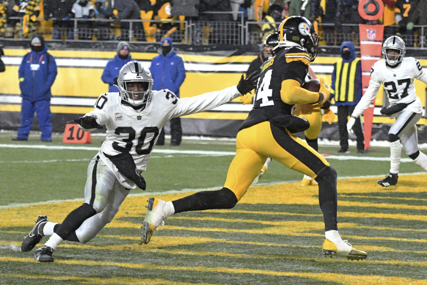 Pittsburgh Steelers wide receiver George Pickens (14) scores with Las Vegas Raiders safety Duron Harmon (30) defending during the second half of an NFL football game in Pittsburgh, Saturday, Dec. 24, 2022. The Steelers won 13-10. (AP Photo/Fred Vuich)