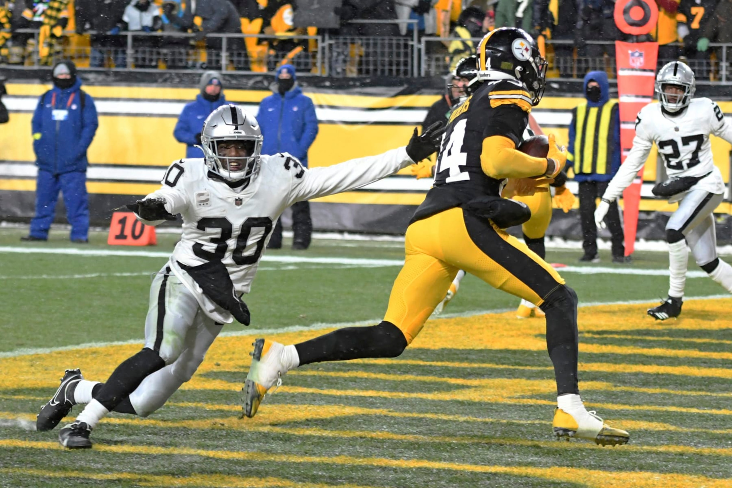 Pittsburgh Steelers wide receiver George Pickens (14) scores with Las Vegas Raiders safety Duron Harmon (30) defending during the second half of an NFL football game in Pittsburgh, Saturday, Dec. 24, 2022. The Steelers won 13-10. (AP Photo/Fred Vuich)