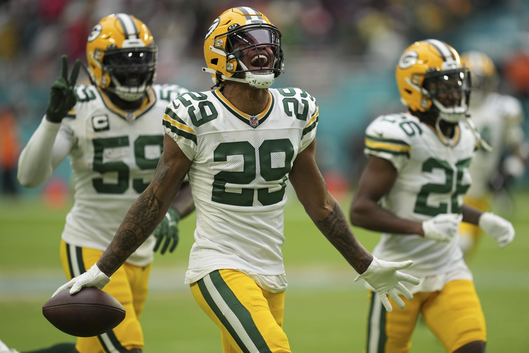 Green Bay Packers cornerback Rasul Douglas (29) celebrates making an interception, during the second half of an NFL football game against the Miami Dolphins, Sunday, Dec. 25, 2022, in Miami Gardens, Fla. (AP Photo/Jim Rassol)