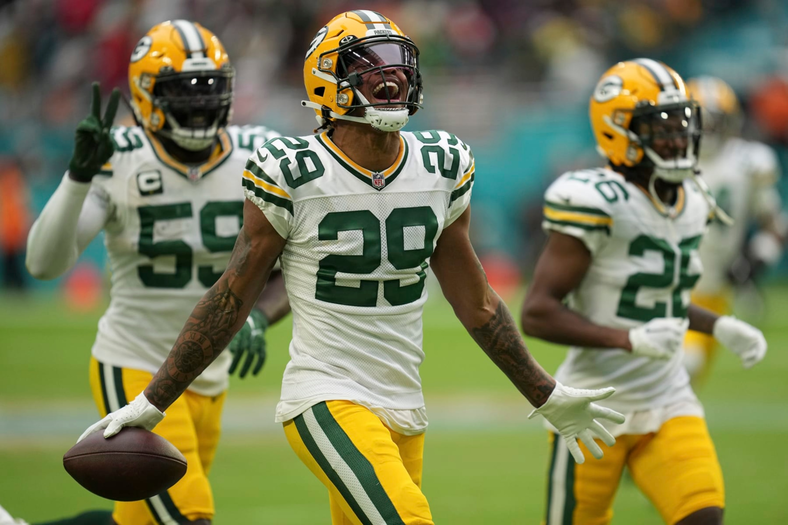 Green Bay Packers cornerback Rasul Douglas (29) celebrates making an interception, during the second half of an NFL football game against the Miami Dolphins, Sunday, Dec. 25, 2022, in Miami Gardens, Fla. (AP Photo/Jim Rassol)