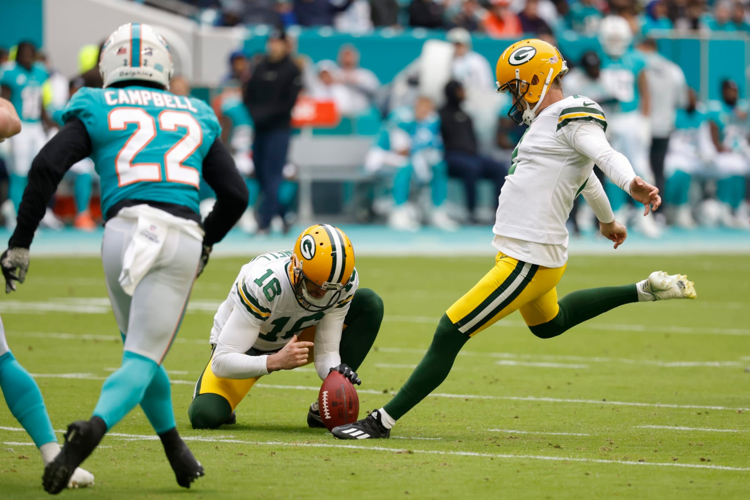 Green Bay Packers place kicker Mason Crosby (2) kicks a field goal, held by Green Bay Packers punter Pat O'Donnell (16) during the first half of an NFL football game, Sunday, Dec. 25, 2022, in Miami Gardens, Fla. (AP Photo/Rhona Wise)