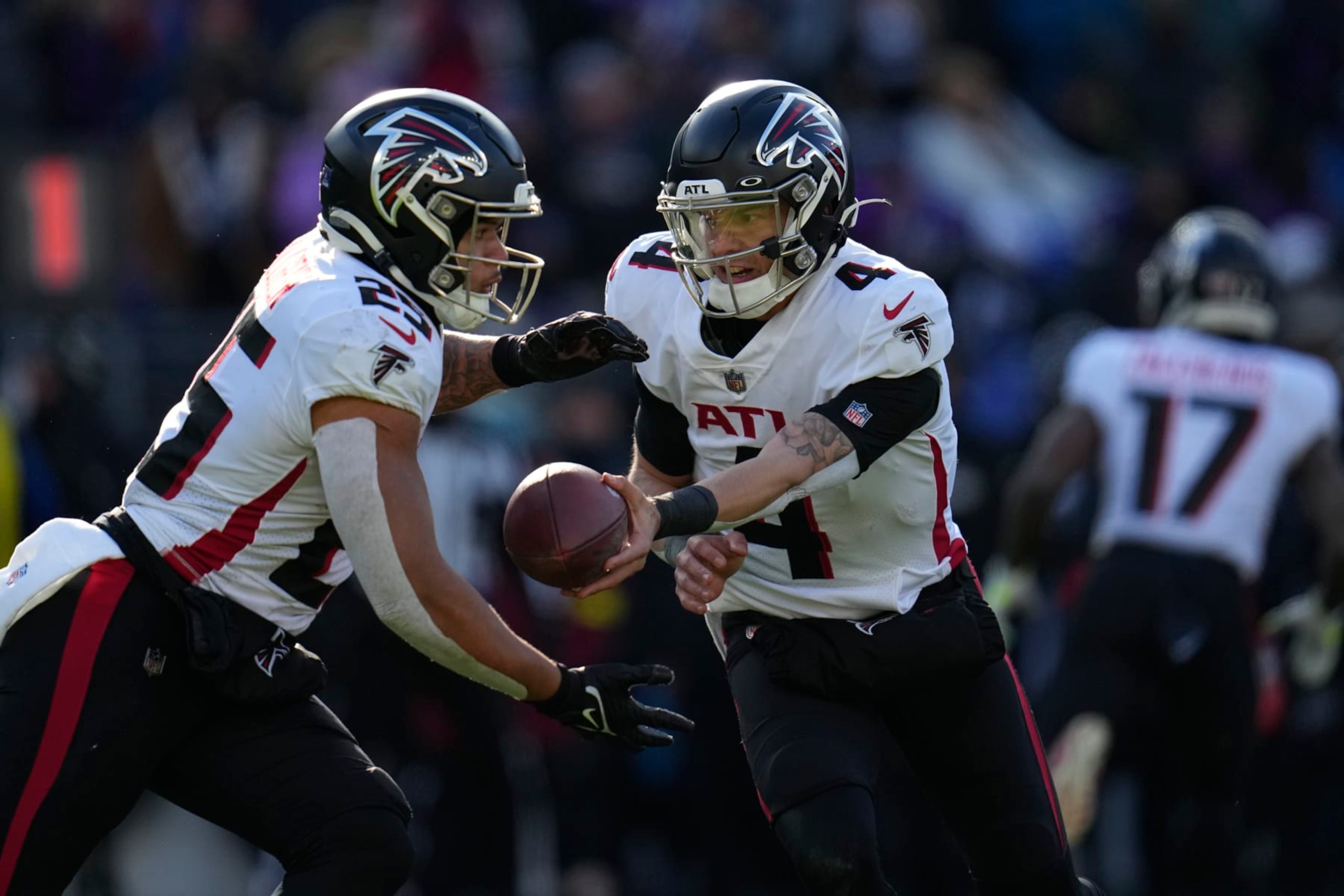 Atlanta Falcons quarterback Desmond Ridder (4) hands off to running back Tyler Allgeier (25) during the first half of an NFL football game against the Baltimore Ravens, Saturday, Dec. 24, 2022, in Baltimore. (AP Photo/Julio Cortez)