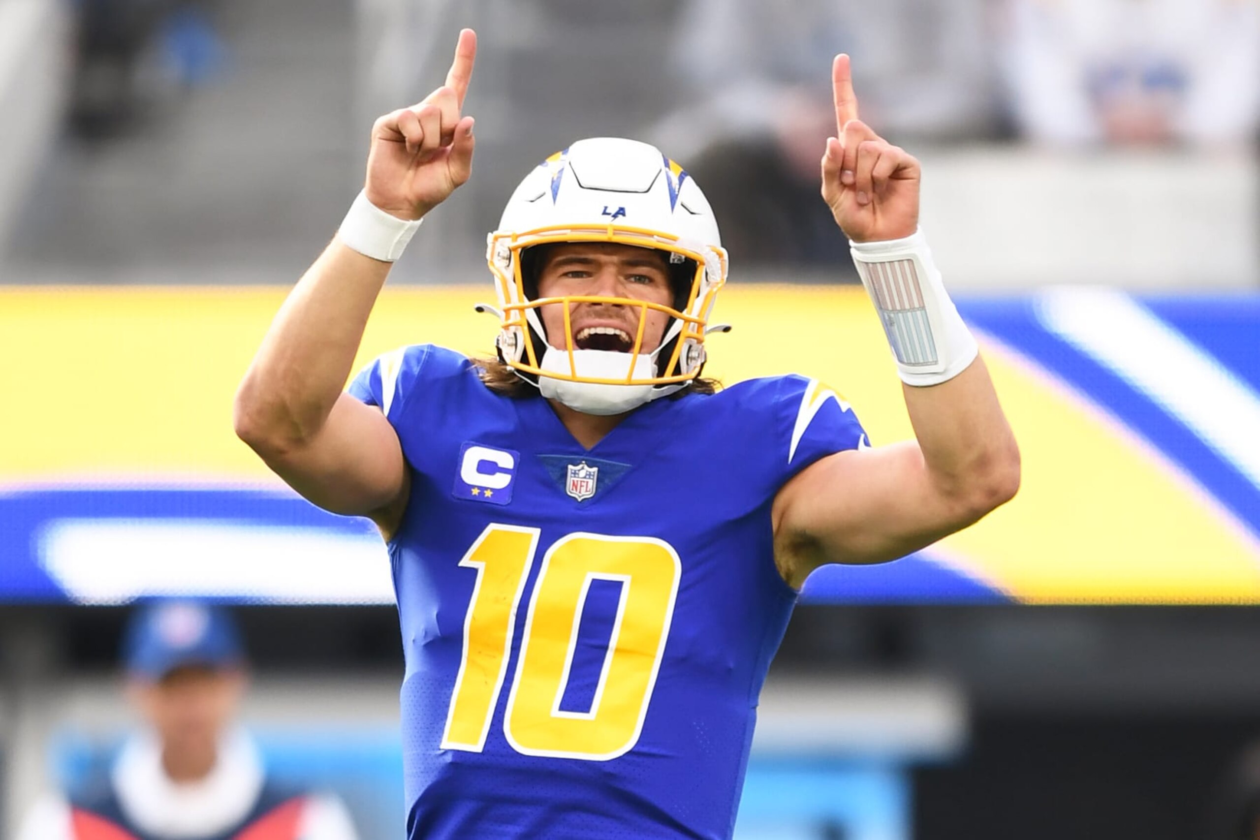 INGLEWOOD, CA - DECEMBER 18: Los Angeles Chargers quarterback Justin Herbert (10) celebrates during the NFL regular season game between the Tennessee Titans and the Los Angeles Chargers on December 18, 2022, at SoFi Stadium in Inglewood, CA. (Photo by Brian Rothmuller/Icon Sportswire via Getty Images)