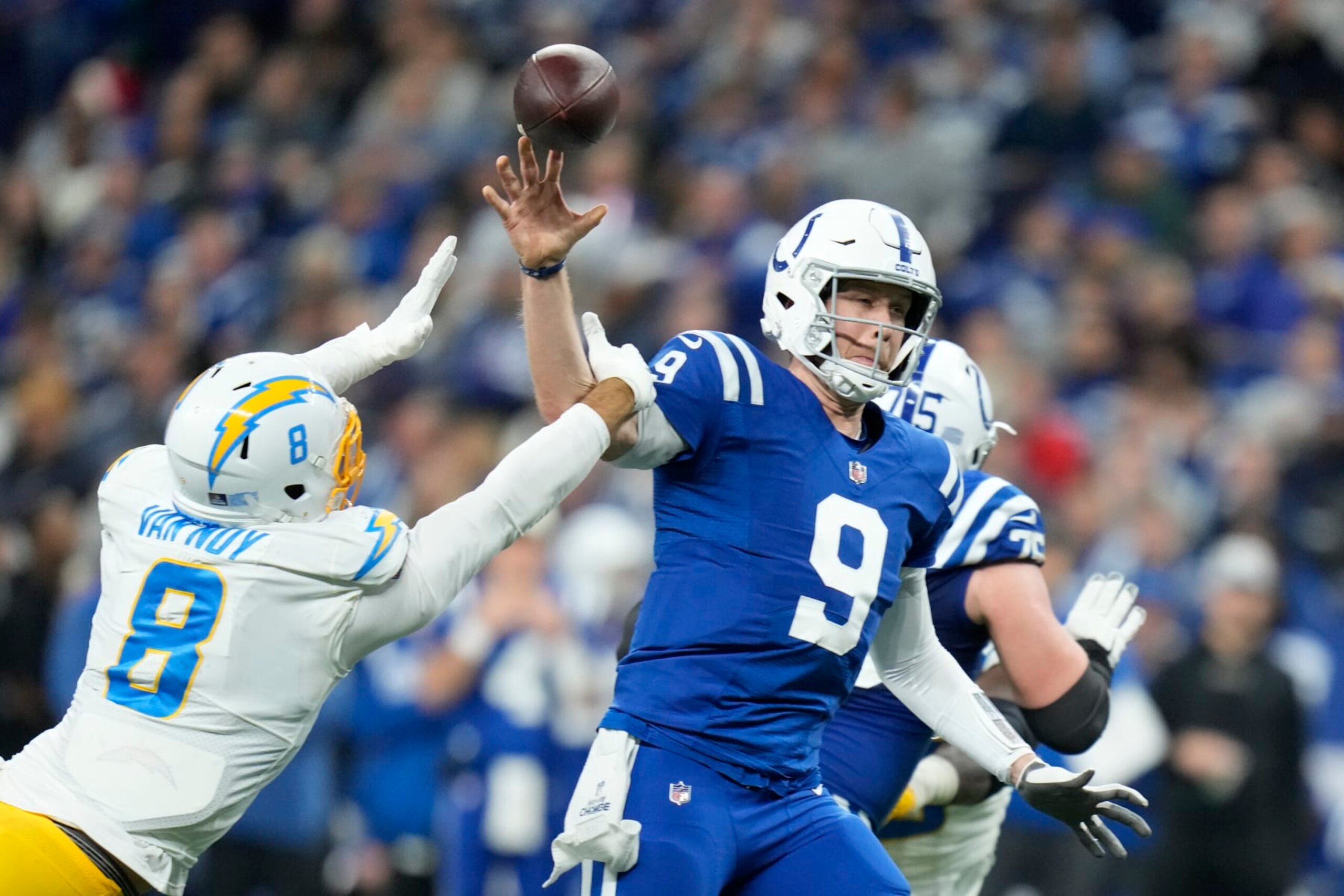 Indianapolis Colts quarterback Nick Foles throws as he is hit by Los Angeles Chargers' Kyle Van Noy (8) during the second half of an NFL football game, Monday, Dec. 26, 2022, in Indianapolis. (AP Photo/Michael Conroy)