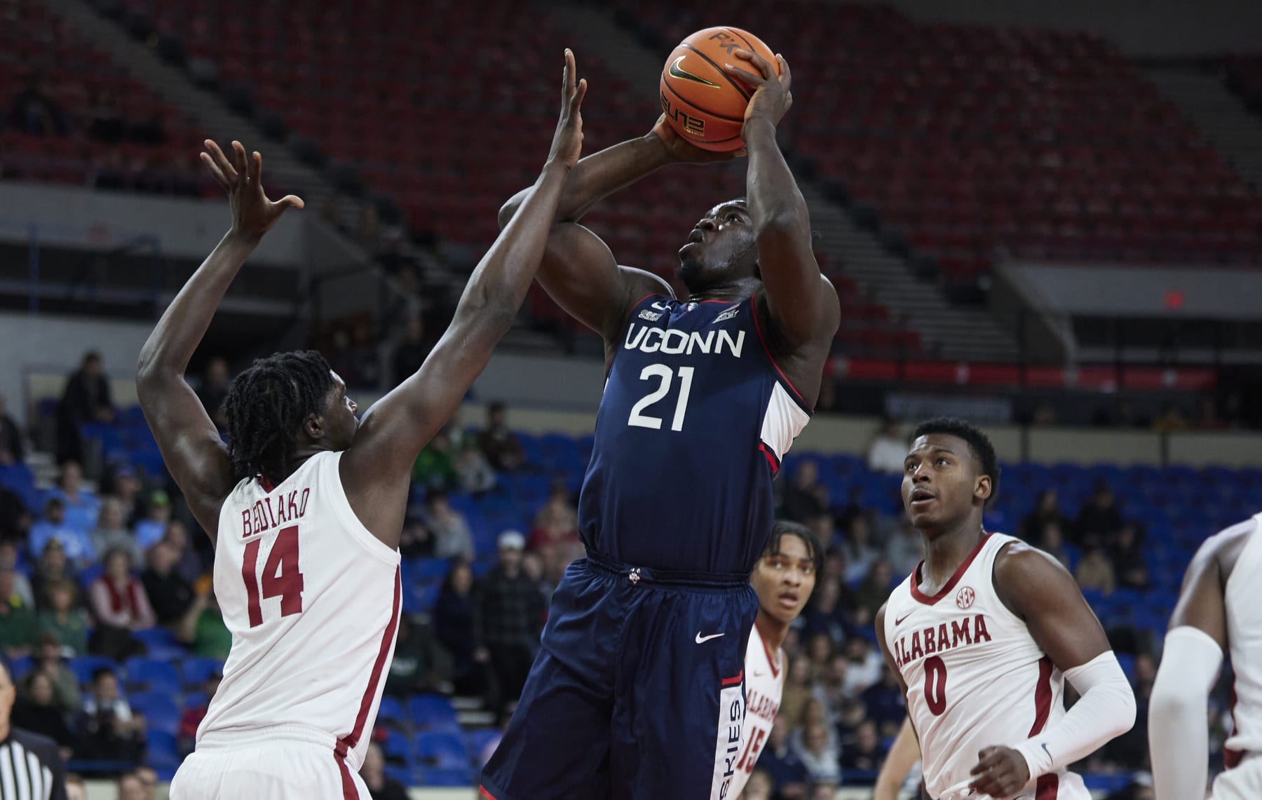 Connecticut's Adama Sanogo; Alabama's Charles Bediako (14) and Jaden Bradley (0)