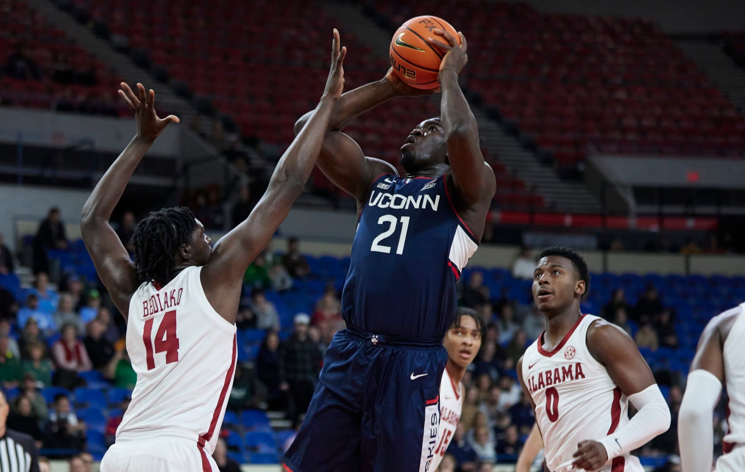 Connecticut's Adama Sanogo; Alabama's Charles Bediako (14) and Jaden Bradley (0) Connecticut's Adama Sanogo; Alabama's Charles Bediako (14) and Jaden Bradley (0)