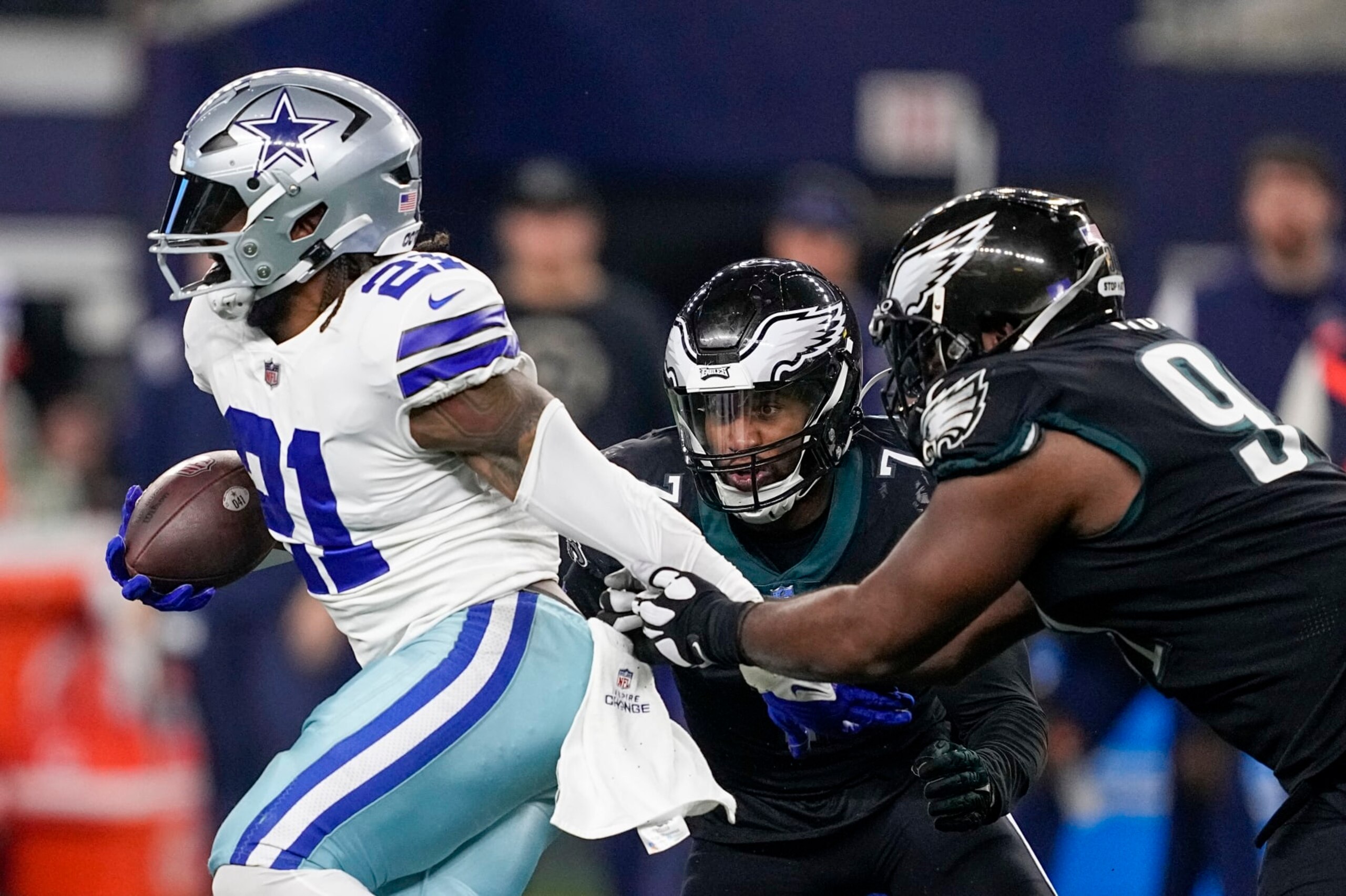 Philadelphia Eagles' Fletcher Cox and Haason Reddick stop Dallas Cowboys' Ezekiel Elliott during the second half of an NFL football game Saturday, Dec. 24, 2022, in Arlington, Texas. (AP Photo/Tony Gutierrez) Philadelphia Eagles' Fletcher Cox and Haason Reddick stop Dallas Cowboys' Ezekiel Elliott during the second half of an NFL football game Saturday, Dec. 24, 2022, in Arlington, Texas. (AP Photo/Tony Gutierrez)