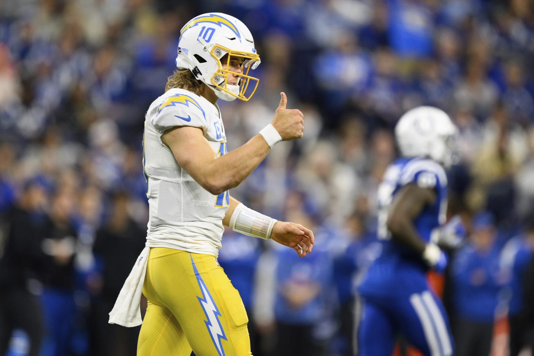 Los Angeles Chargers quarterback Justin Herbert (10) gives the sideline a thumbs up after a first down throw during an NFL football game against the Indianapolis Colts, Monday, Dec. 26, 2022, in Indianapolis. (AP Photo/Zach Bolinger)