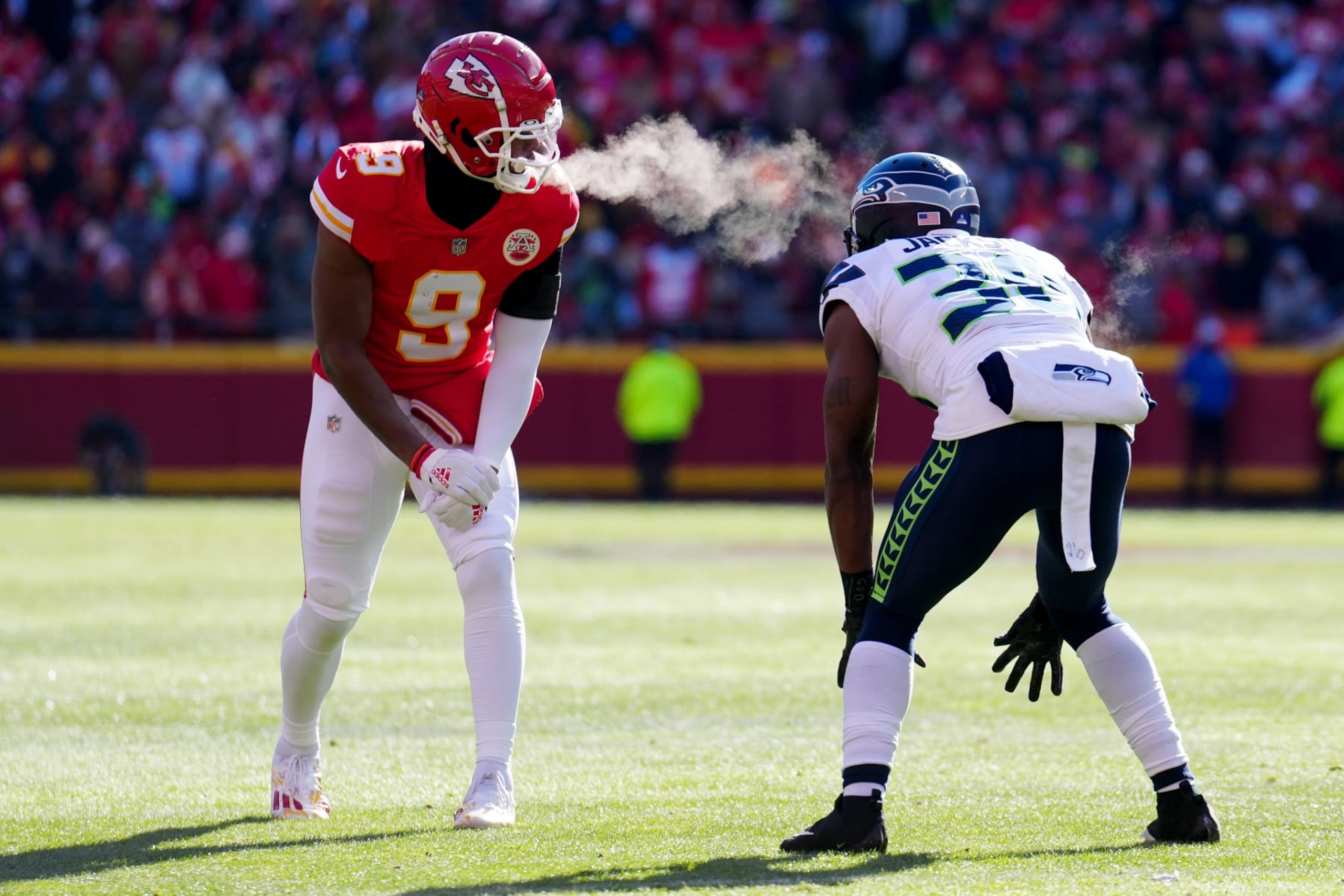 KANSAS CITY, MISSOURI - DECEMBER 24: JuJu Smith-Schuster #9 of the Kansas City Chiefs and Mike Jackson #30 of the Seattle Seahawks line up before a play during the first quarter at Arrowhead Stadium on December 24, 2022 in Kansas City, Missouri. (Photo by Jason Hanna/Getty Images)