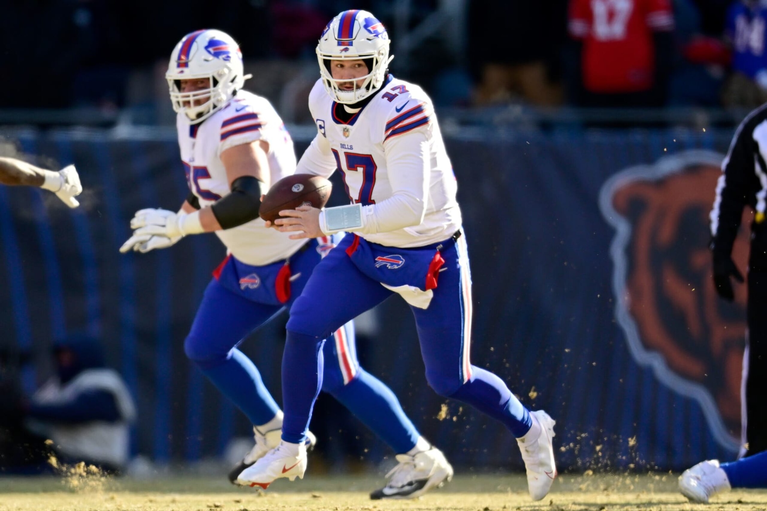 CHICAGO, ILLINOIS - DECEMBER 24: Josh Allen #17 of the Buffalo Bills runs the ball during the first half in the game against the Chicago Bears at Soldier Field on December 24, 2022 in Chicago, Illinois. (Photo by Quinn Harris/Getty Images)