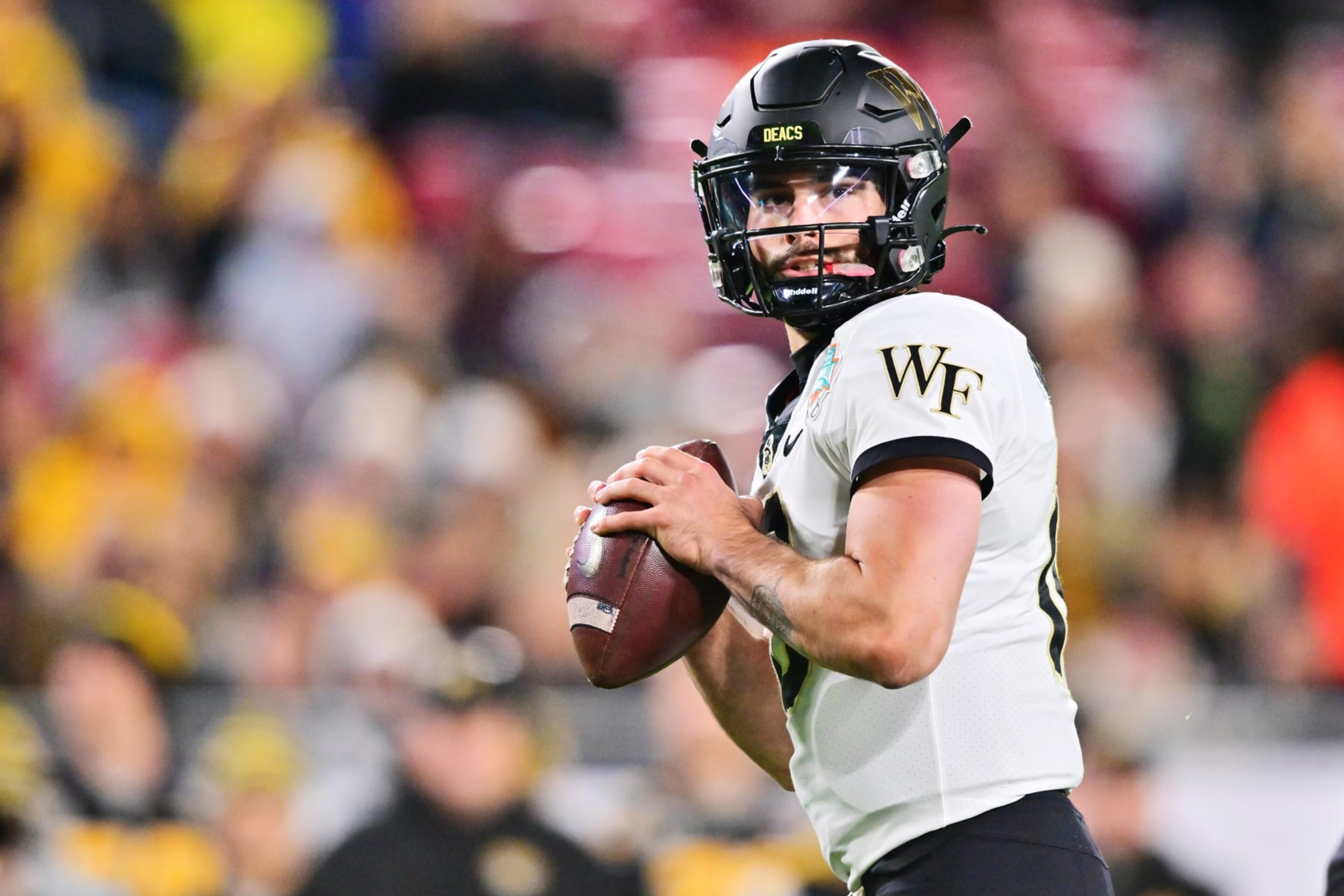 TAMPA, FLORIDA - DECEMBER 23: Sam Hartman #10 of the Wake Forest Demon Deacons looks to throw a pass in the first quarter against the Missouri Tigers during the Union Home Mortgage Gasparilla Bowl at Raymond James Stadium on December 23, 2022 in Tampa, Florida. (Photo by Julio Aguilar/Getty Images) TAMPA, FLORIDA - DECEMBER 23: Sam Hartman #10 of the Wake Forest Demon Deacons looks to throw a pass in the first quarter against the Missouri Tigers during the Union Home Mortgage Gasparilla Bowl at Raymond James Stadium on December 23, 2022 in Tampa, Florida. (Photo by Julio Aguilar/Getty Images)