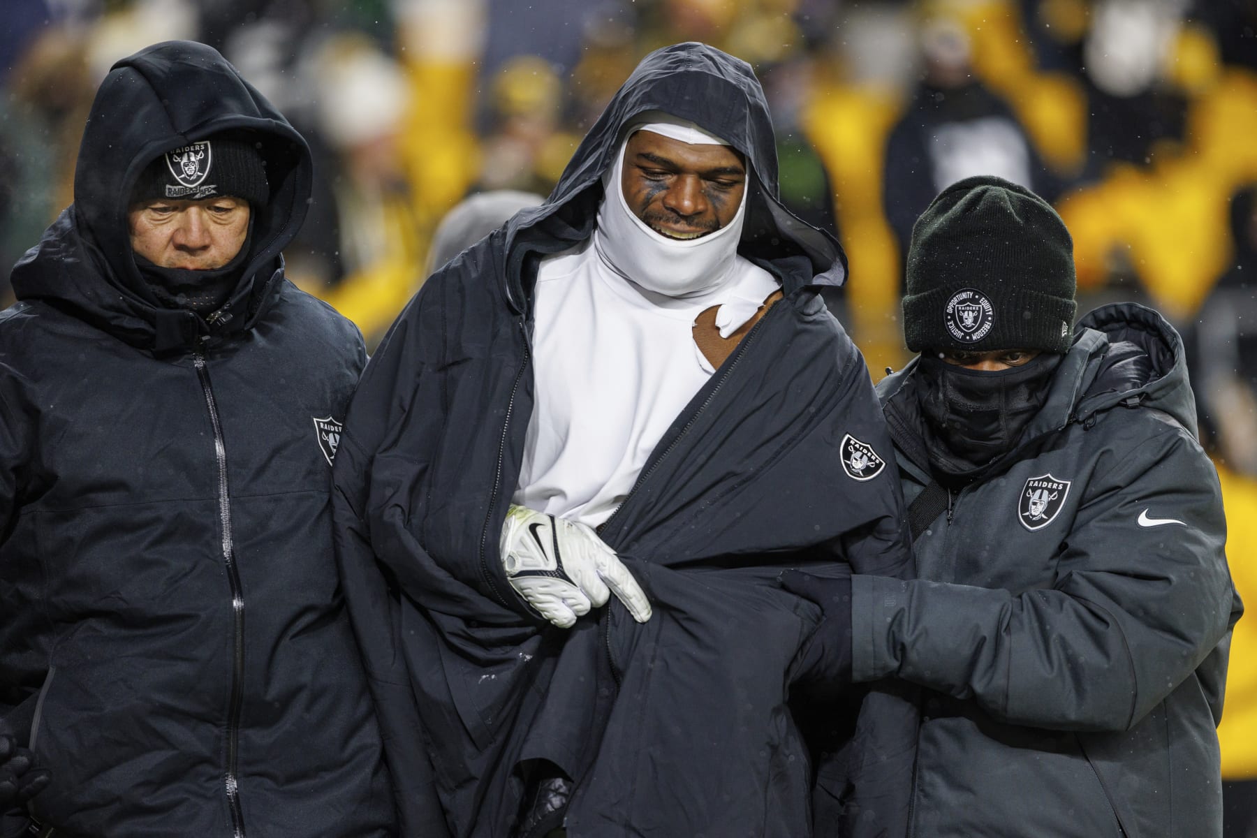 Las Vegas Raiders linebacker Denzel Perryman (52) is helped while walking to the locker room during an NFL football game, Saturday, Dec. 24, 2022, in Pittsburgh, PA. (AP Photo/Matt Durisko)