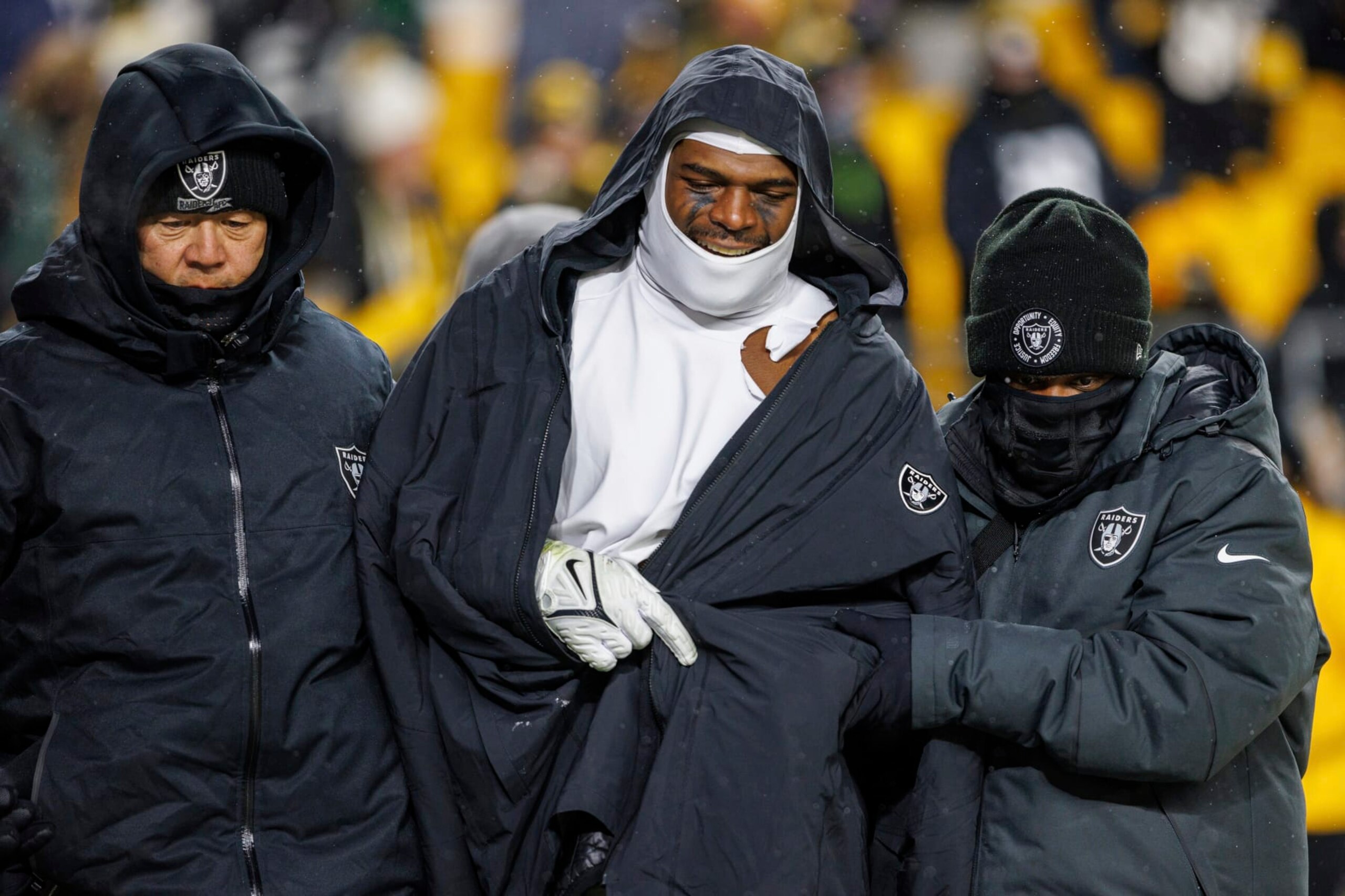 Las Vegas Raiders linebacker Denzel Perryman (52) is helped while walking to the locker room during an NFL football game, Saturday, Dec. 24, 2022, in Pittsburgh, PA. (AP Photo/Matt Durisko)