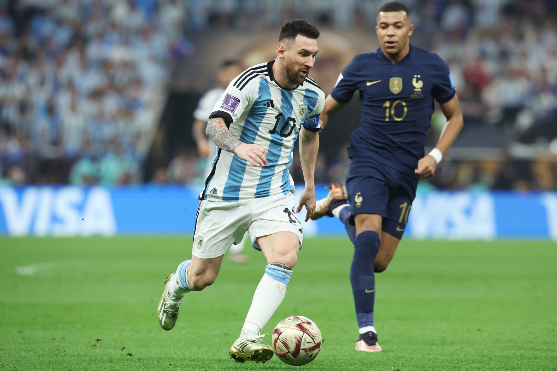 LUSAIL CITY, QATAR - DECEMBER 18: Lionel Messi of Argentina runs past Kylian Mbappe of Fran during the FIFA World Cup Qatar 2022 Final match between Argentina and France at Lusail Stadium on December 18, 2022 in Lusail City, Qatar. (Photo by Mark Metcalfe - FIFA/FIFA via Getty Images)