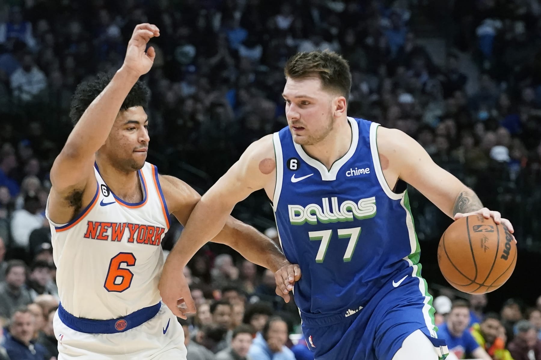 Dallas Mavericks guard Luka Doncic (77) drives against New York Knicks guard Quentin Grimes (6) during the first quarter of an NBA basketball game in Dallas, Tuesday, Dec. 27, 2022. (AP Photo/LM Otero)