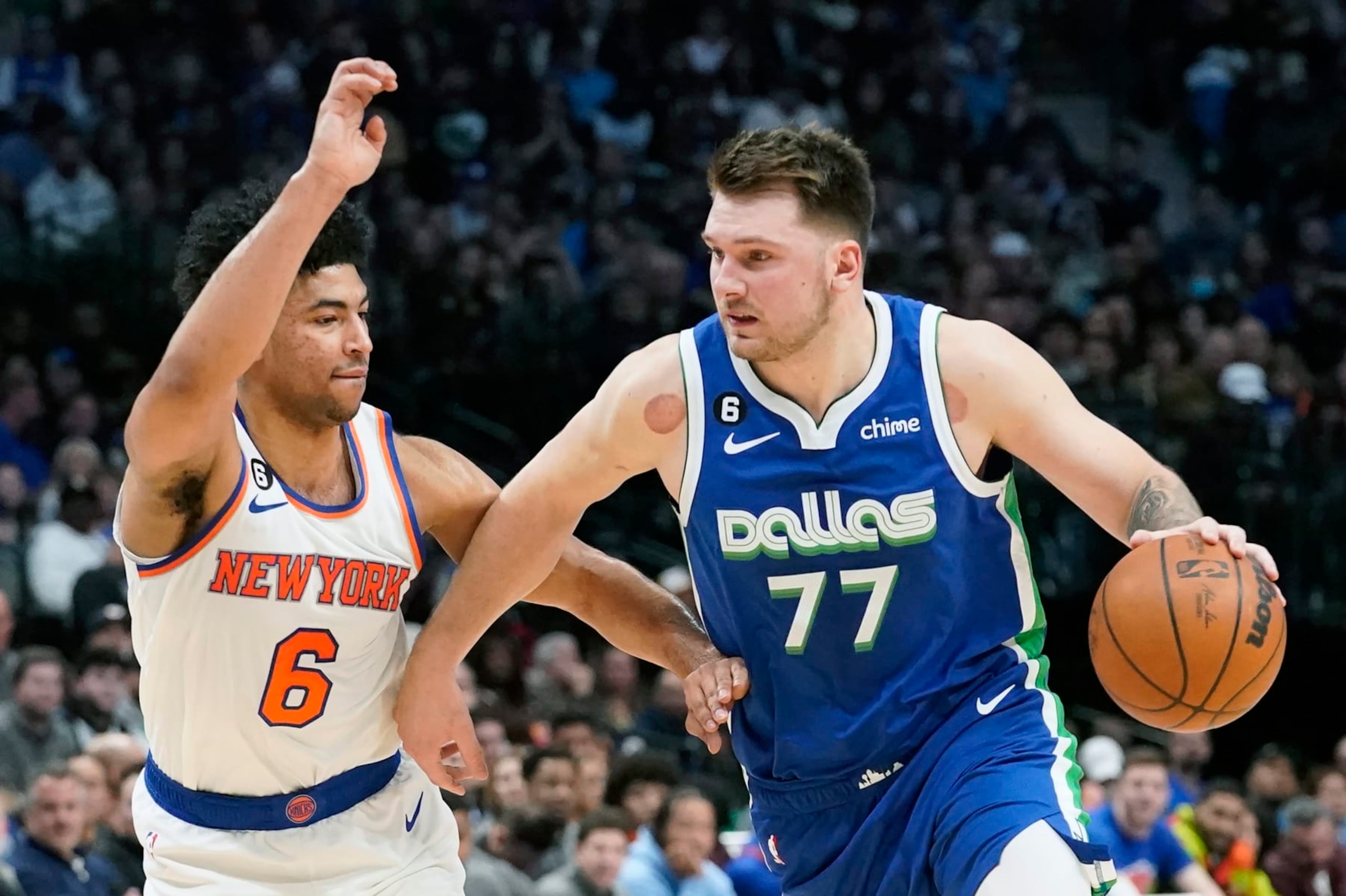 Dallas Mavericks guard Luka Doncic (77) drives against New York Knicks guard Quentin Grimes (6) during the first quarter of an NBA basketball game in Dallas, Tuesday, Dec. 27, 2022. (AP Photo/LM Otero)