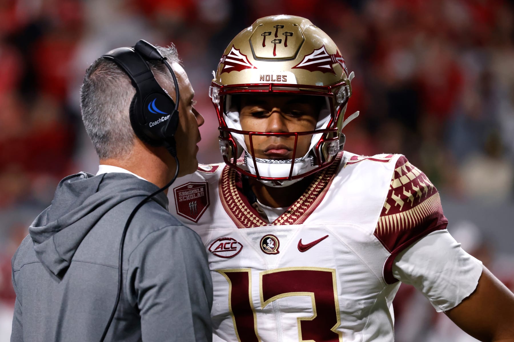Florida State's Mike Norvell speaks with Jordan Travis.