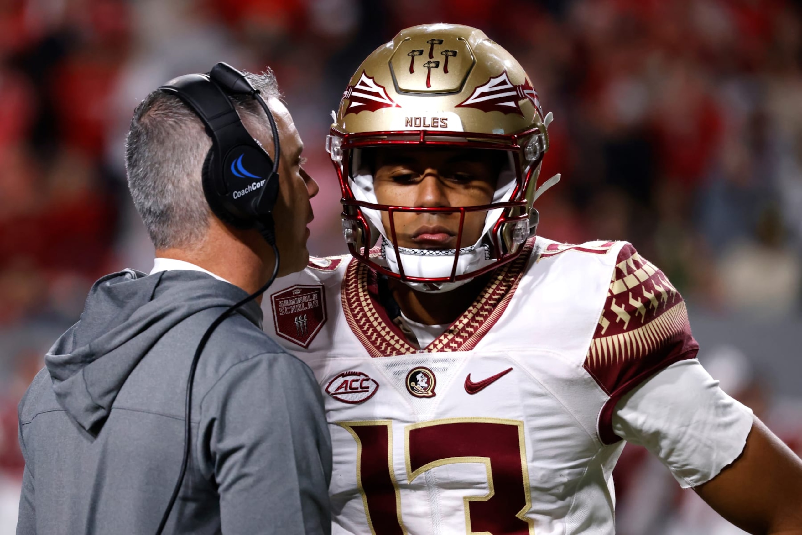Florida State's Mike Norvell speaks with Jordan Travis.