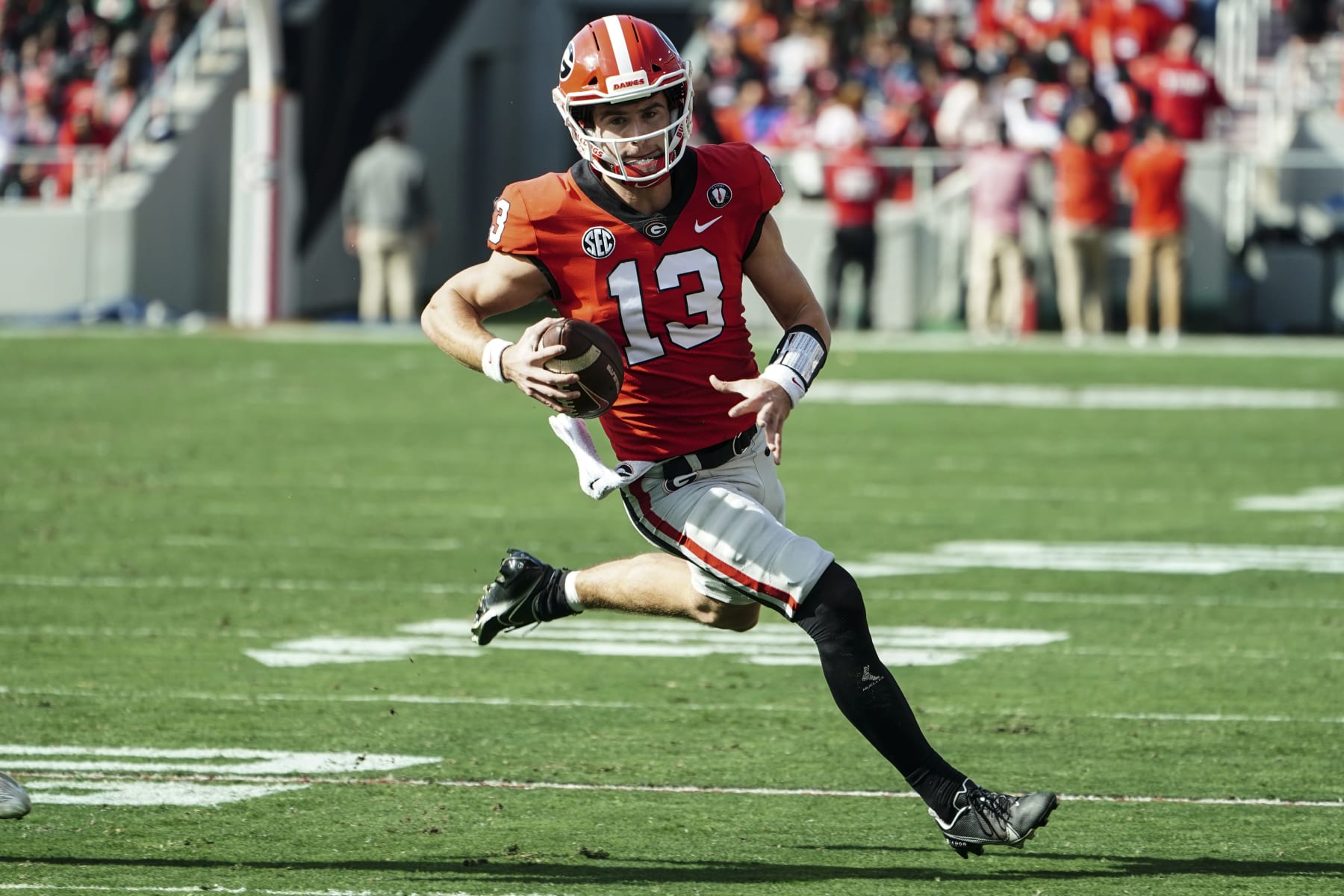 Georgia quarterback Stetson Bennett (13) runs the ball during the first half of an NCAA college football game against Georgia Tech Saturday, Nov. 26, 2022 in Athens, Ga. (AP Photo/John Bazemore)