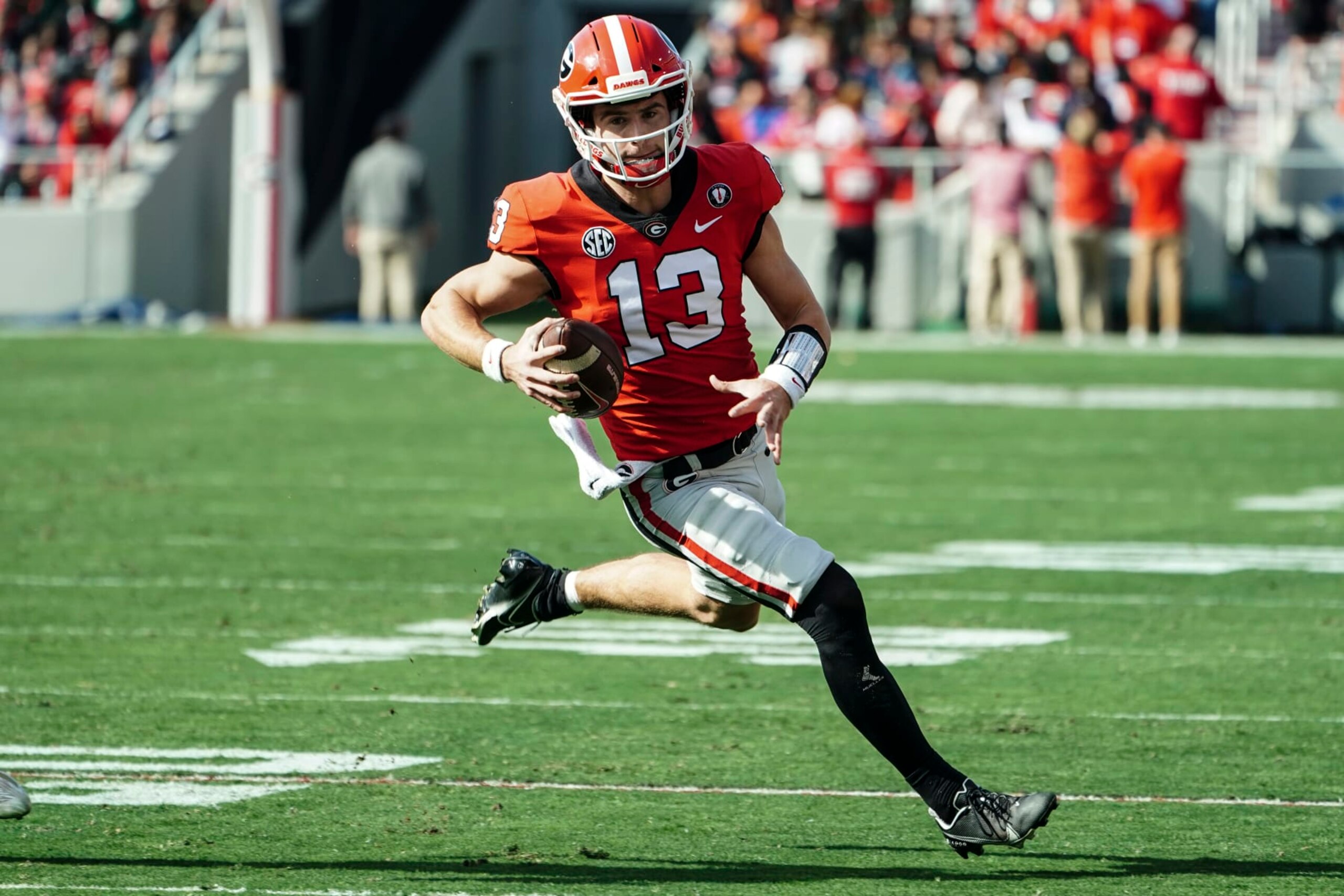 Georgia quarterback Stetson Bennett (13) runs the ball during the first half of an NCAA college football game against Georgia Tech Saturday, Nov. 26, 2022 in Athens, Ga. (AP Photo/John Bazemore)