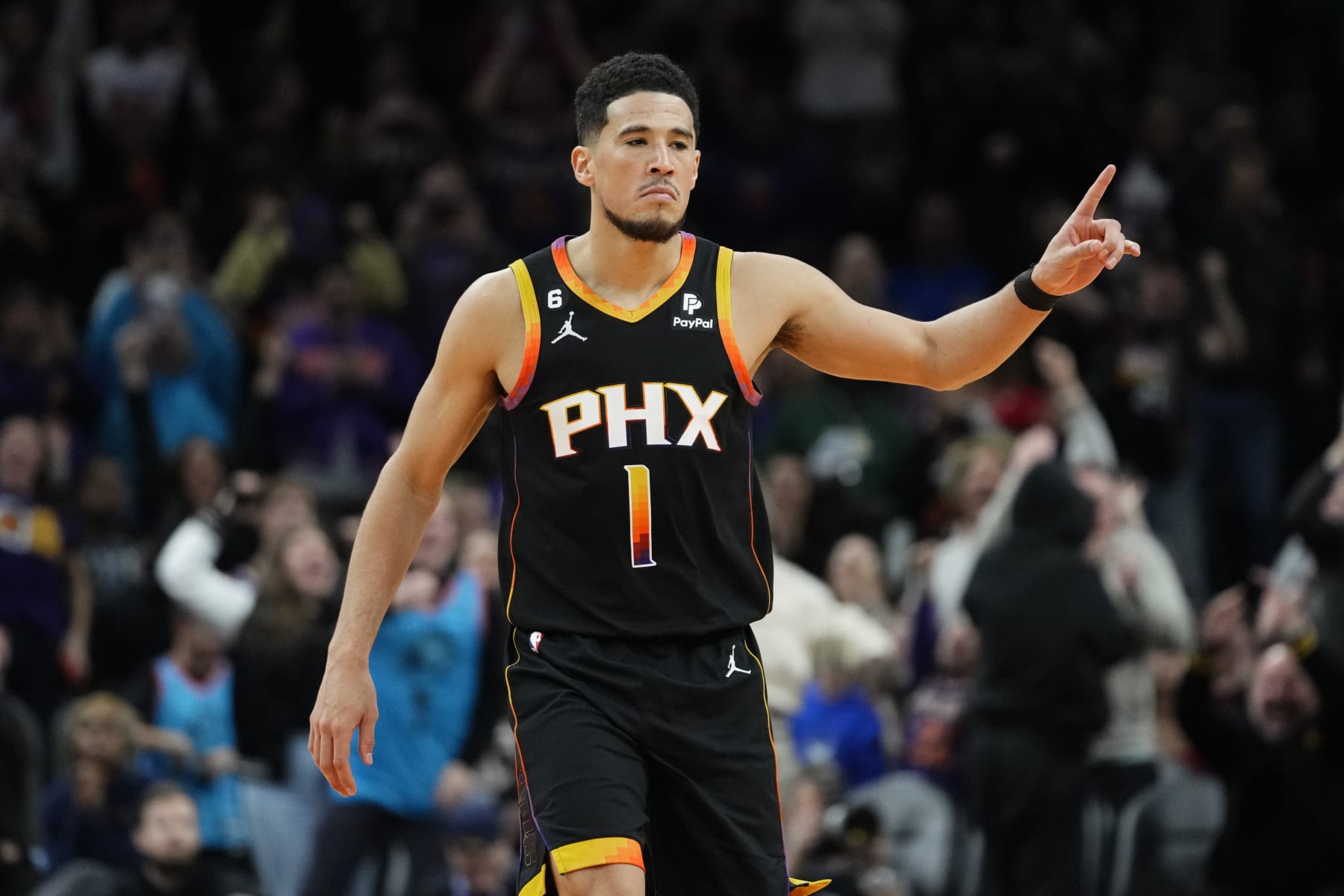 Phoenix Suns guard Devin Booker reacts to a basket during the second half of an NBA basketball game against the New Orleans Pelicans, Saturday, Dec. 17, 2022, in Phoenix. The Suns defeated the Pelicans 118-114. (AP Photo/Matt York)