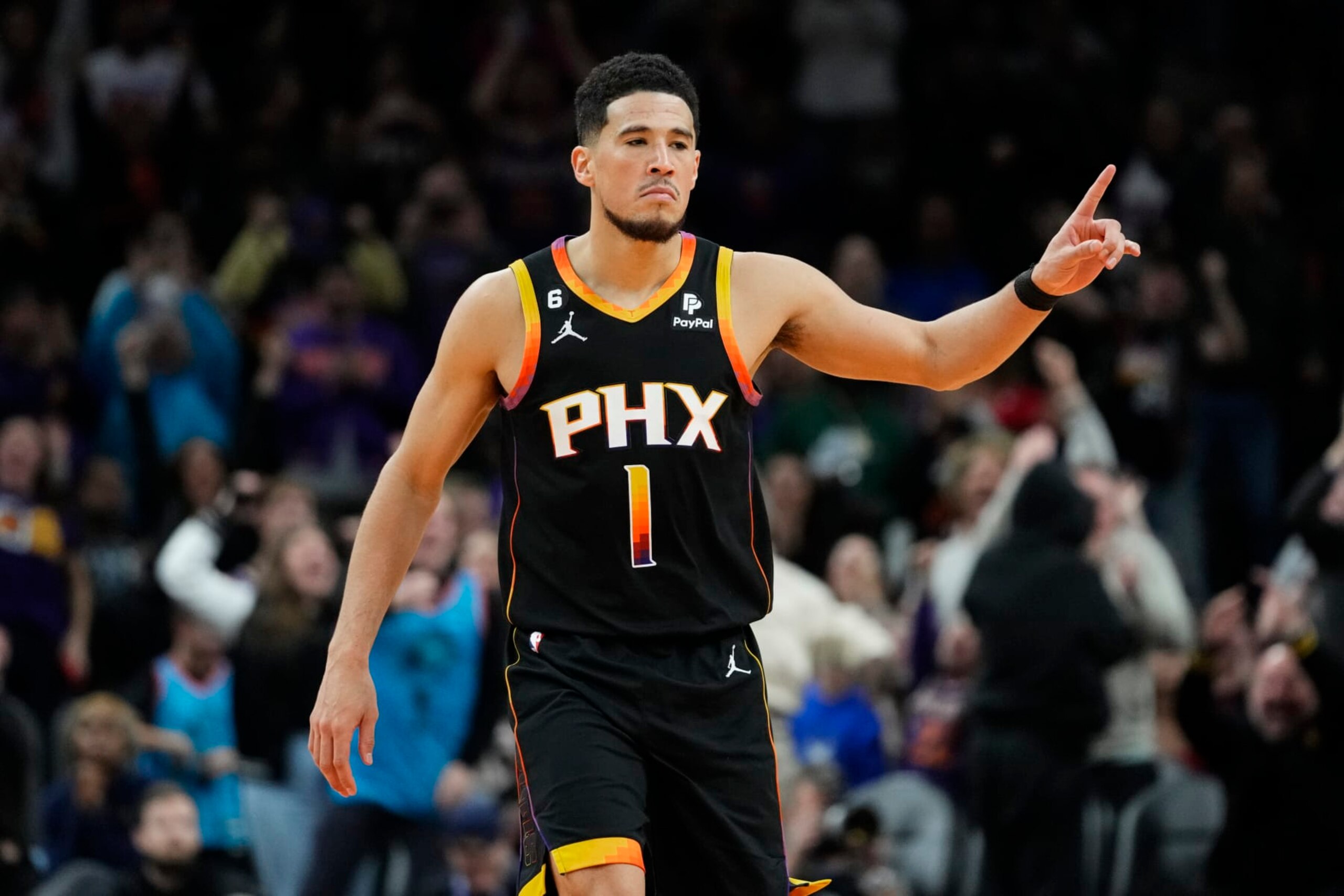 Phoenix Suns guard Devin Booker reacts to a basket during the second half of an NBA basketball game against the New Orleans Pelicans, Saturday, Dec. 17, 2022, in Phoenix. The Suns defeated the Pelicans 118-114. (AP Photo/Matt York)