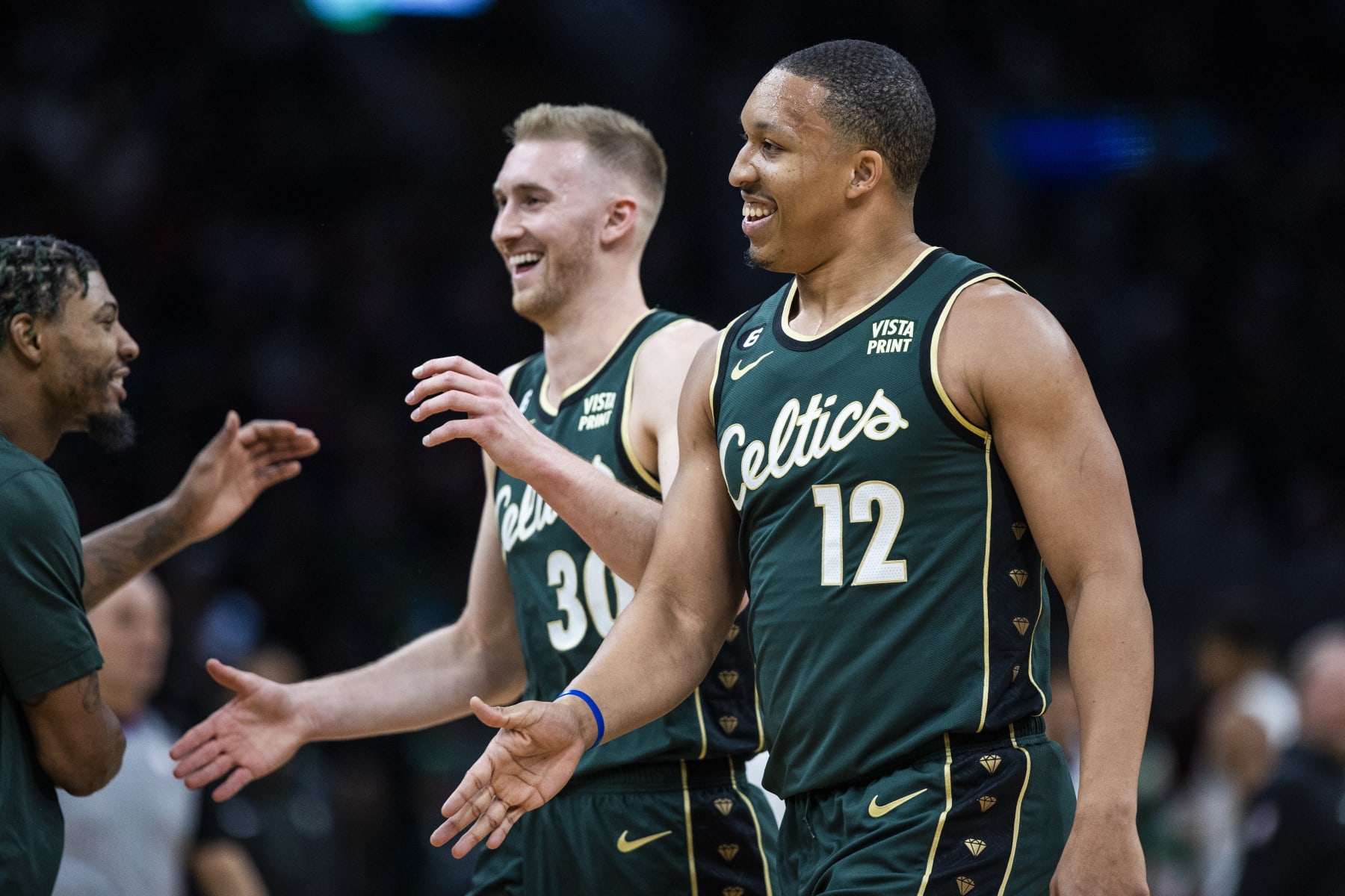 Boston, MA - December 25: Boston Celtics PF Grant Williams, right, and SF Sam Hauser smile as they return to the bench. The Celtics beat the Milwaukee Bucks, 139-118. (Photo by Erin Clark/The Boston Globe via Getty Images)