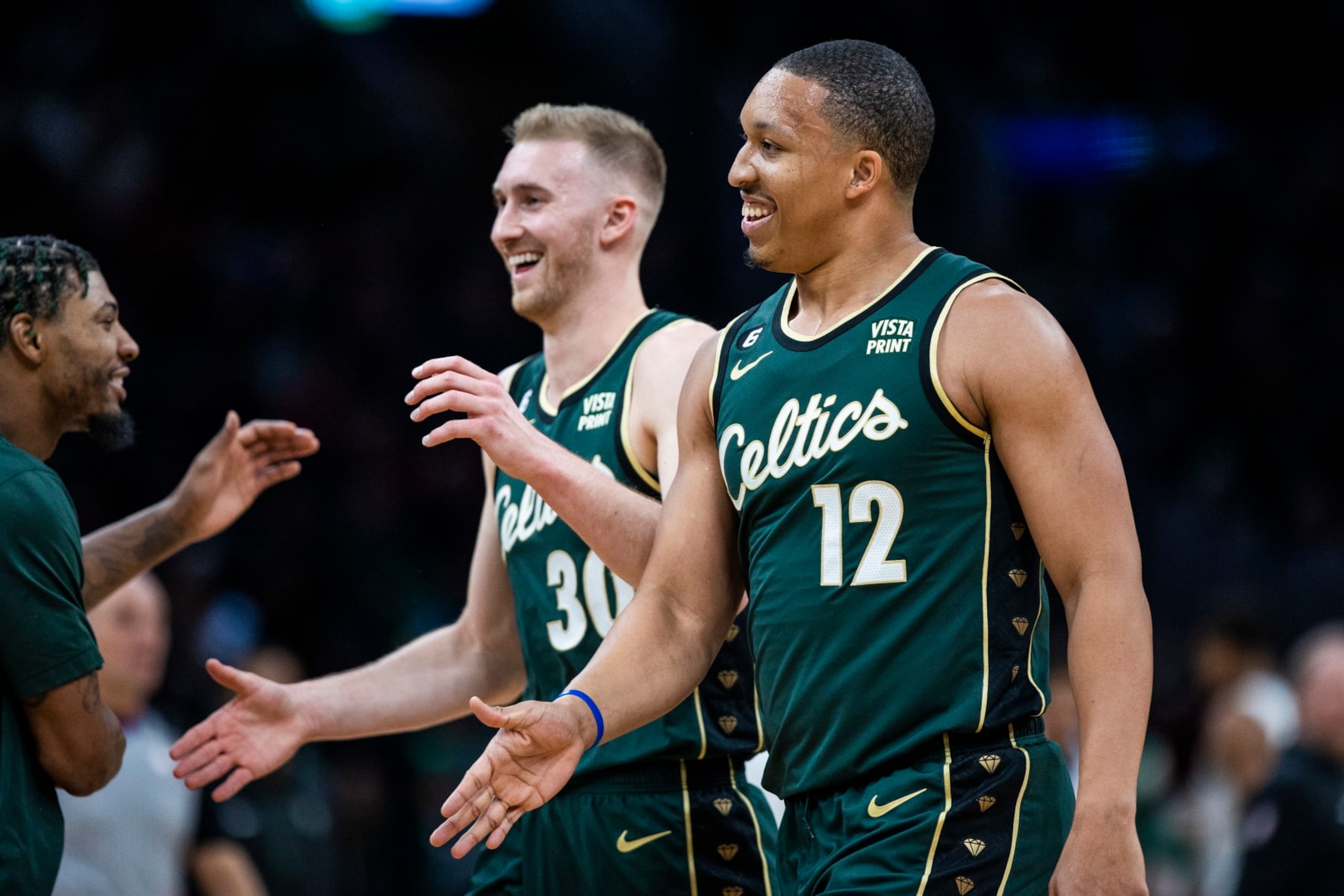 Boston, MA - December 25: Boston Celtics PF Grant Williams, right, and SF Sam Hauser smile as they return to the bench. The Celtics beat the Milwaukee Bucks, 139-118. (Photo by Erin Clark/The Boston Globe via Getty Images) Boston, MA - December 25: Boston Celtics PF Grant Williams, right, and SF Sam Hauser smile as they return to the bench. The Celtics beat the Milwaukee Bucks, 139-118. (Photo by Erin Clark/The Boston Globe via Getty Images)