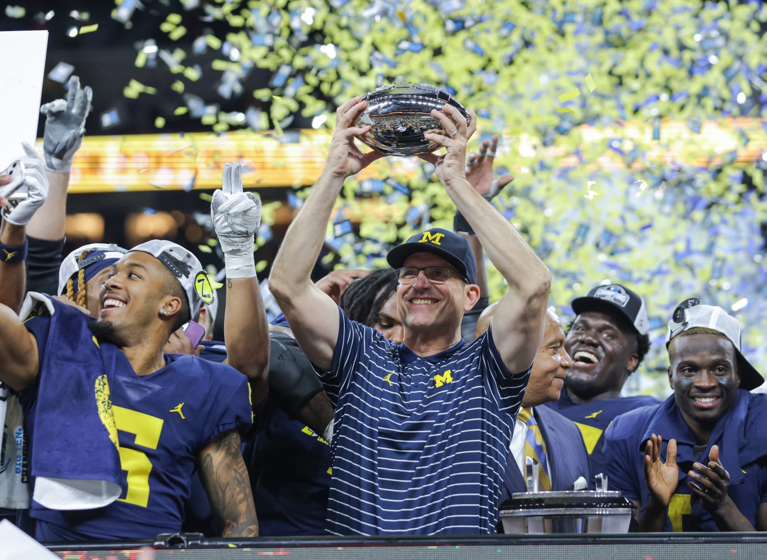 INDIANAPOLIS, IN - DECEMBER 03: Head coach Jim Harbaugh of the Michigan Wolverines holds the Big Ten trophy following the Big Ten Championship against the Purdue Boilermakers at Lucas Oil Stadium on December 3, 2022 in Indianapolis, Indiana. (Photo by Michael Hickey/Getty Images)