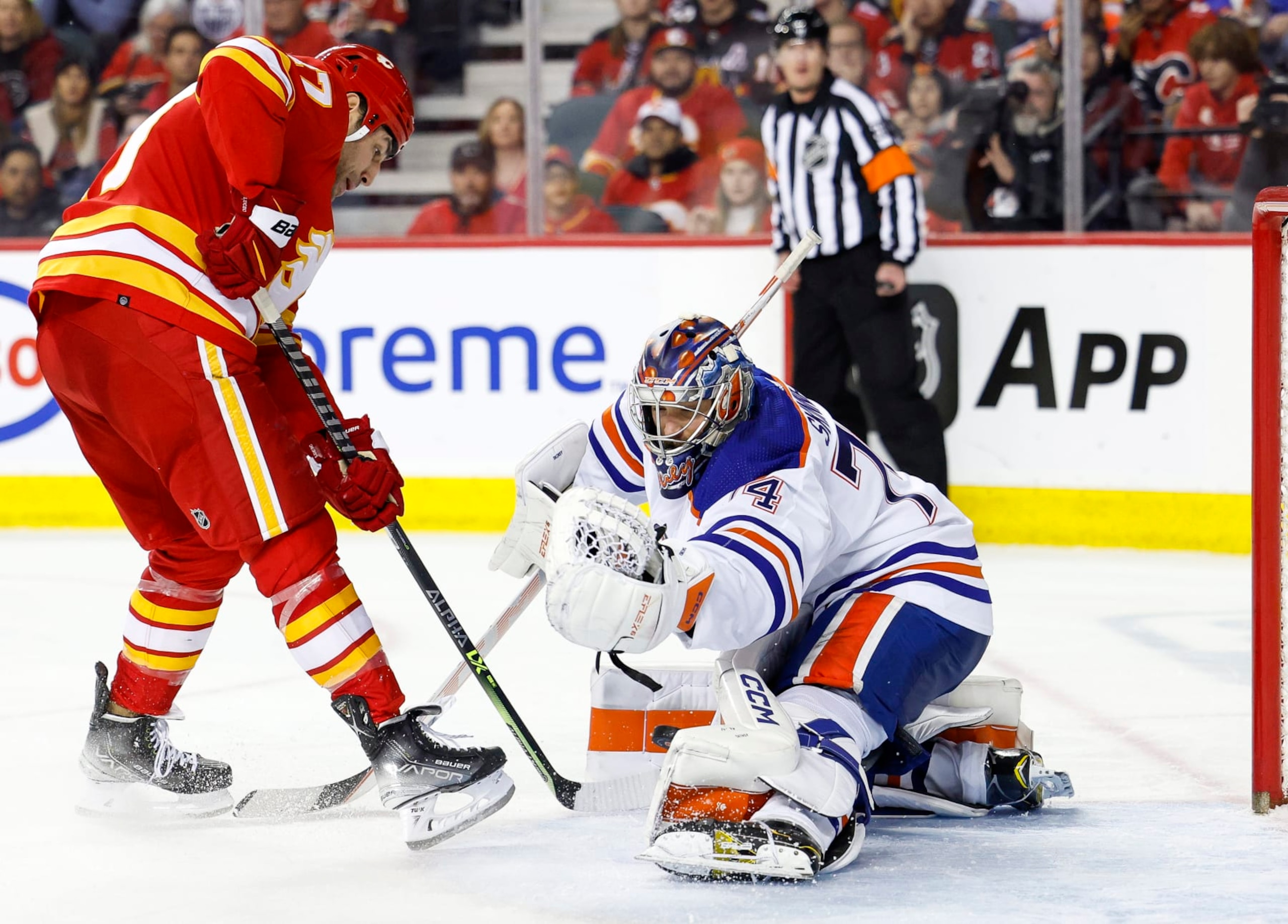 CALGARY, CANADA - DECEMBER 27: Stuart Skinner #74 of the Edmonton Oilers blocks a shot on net from Milan Lucic #17 of the Calgary Flames in the third period at the Scotiabank Saddledome on December 27, 2022, in Calgary, Alberta, Canada. (Photo by Leah Hennel/Getty Images)
