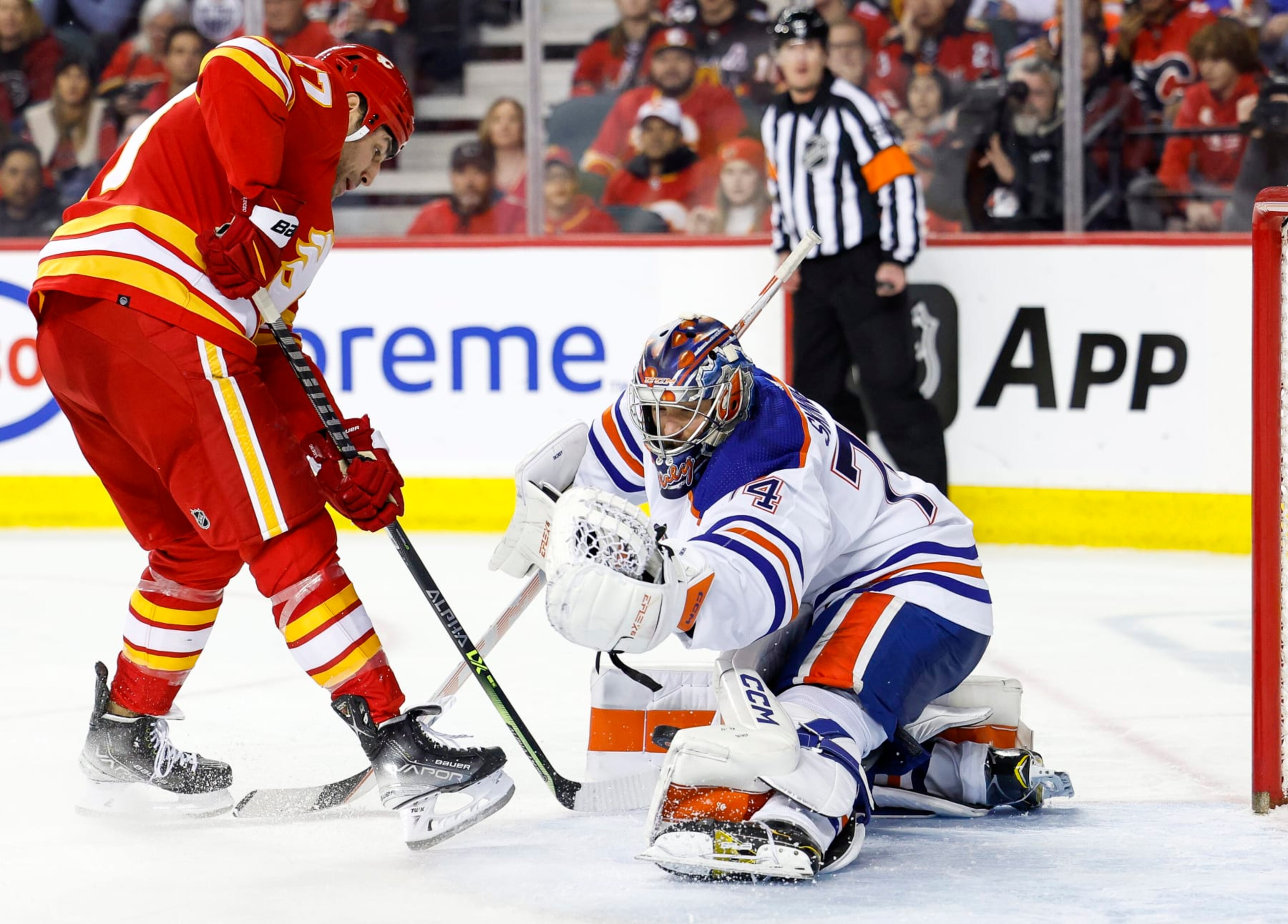 CALGARY, CANADA - DECEMBER 27: Stuart Skinner #74 of the Edmonton Oilers blocks a shot on net from Milan Lucic #17 of the Calgary Flames in the third period at the Scotiabank Saddledome on December 27, 2022, in Calgary, Alberta, Canada. (Photo by Leah Hennel/Getty Images)