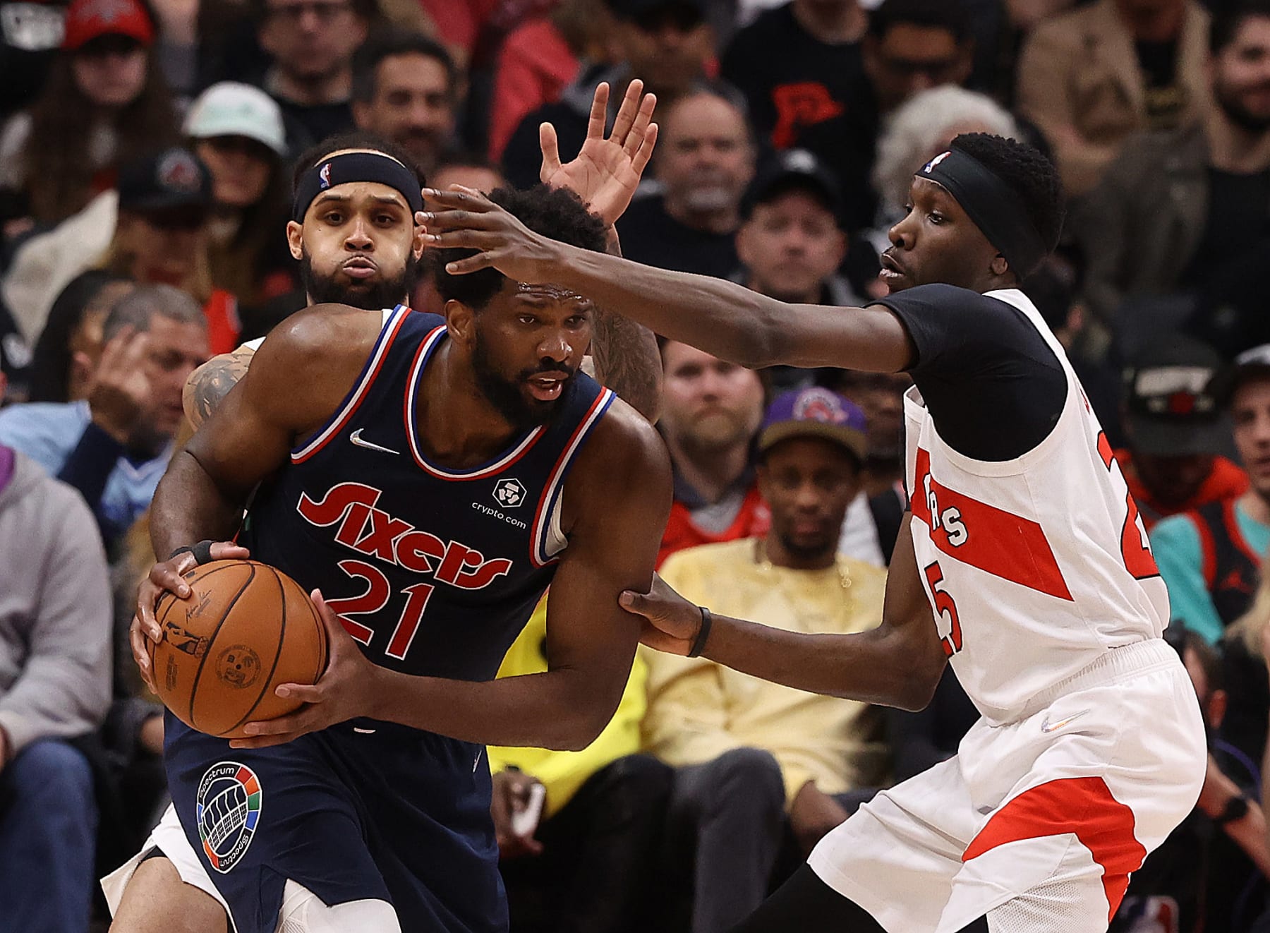 TORONTO, ON- APRIL 28  - Toronto Raptors forward Chris Boucher (25) and Toronto Raptors guard Gary Trent Jr. (33) defend Philadelphia 76ers center Joel Embiid (21) as the Toronto Raptors fall the Philadelphia 76ers in Game 6 and lose their first round NBA playoff series 4-2 in Scotiabank Arena in Toronto. April 28, 2022.        (Steve Russell/Toronto Star via Getty Images)