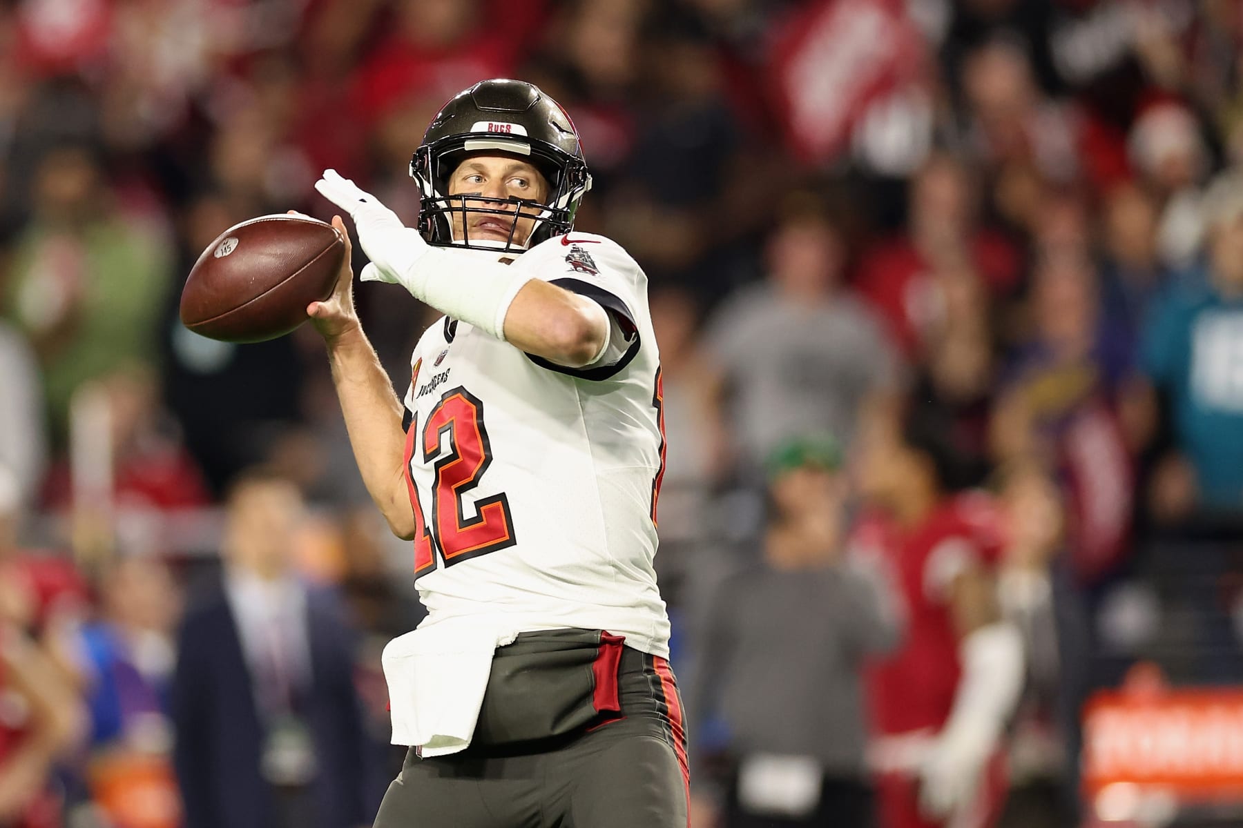 GLENDALE, ARIZONA - DECEMBER 25: Quarterback Tom Brady #12 of the Tampa Bay Buccaneers drops back to pass during the NFL game against the Arizona Cardinals at State Farm Stadium on December 25, 2022 in Glendale, Arizona. The Buccaneers defeated the Cardinals 19-16 in overtime.  (Photo by Christian Petersen/Getty Images)
