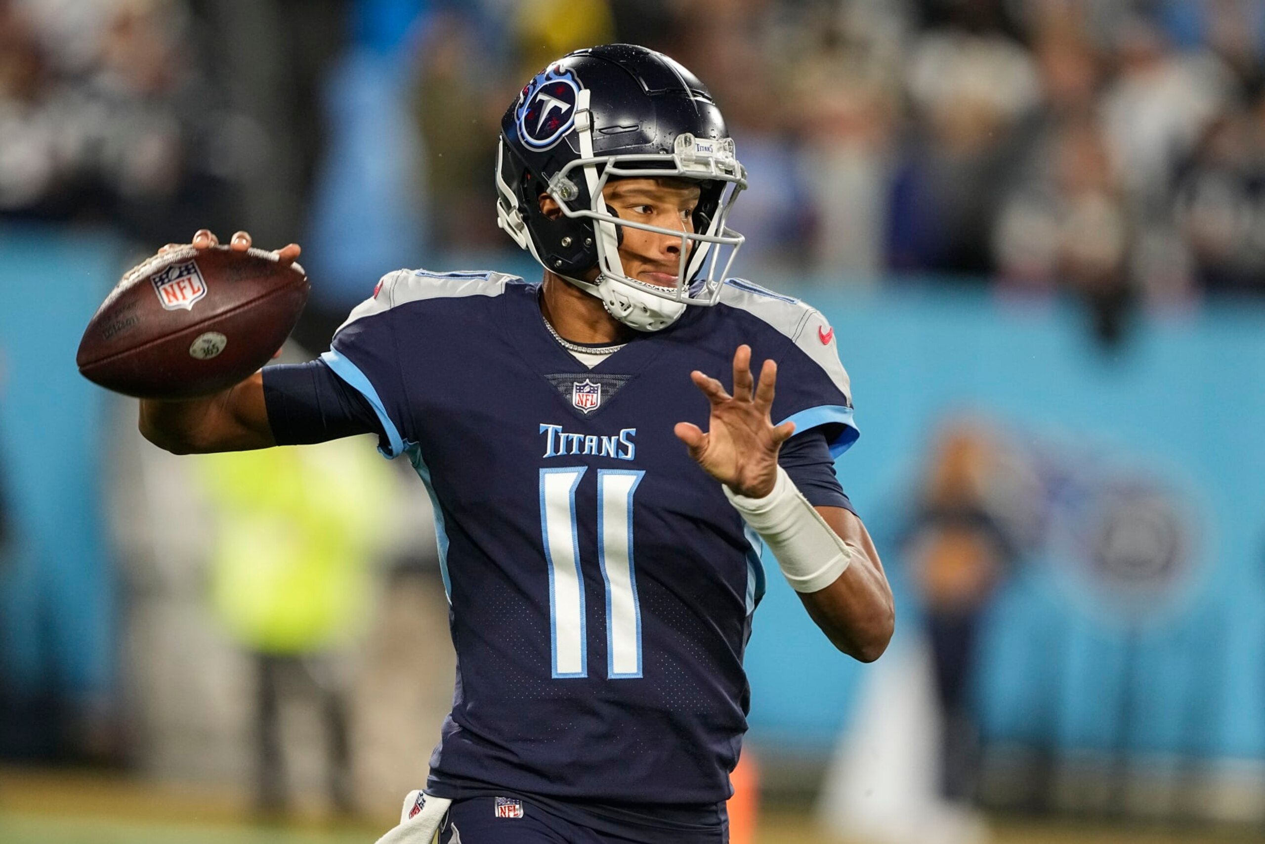 Tennessee Titans quarterback Joshua Dobbs (11) throws out of the pocket against the Dallas Cowboys during the first half of an NFL football game, Thursday, Dec. 29, 2022, in Nashville, Tenn. (AP Photo/Chris Carlson)