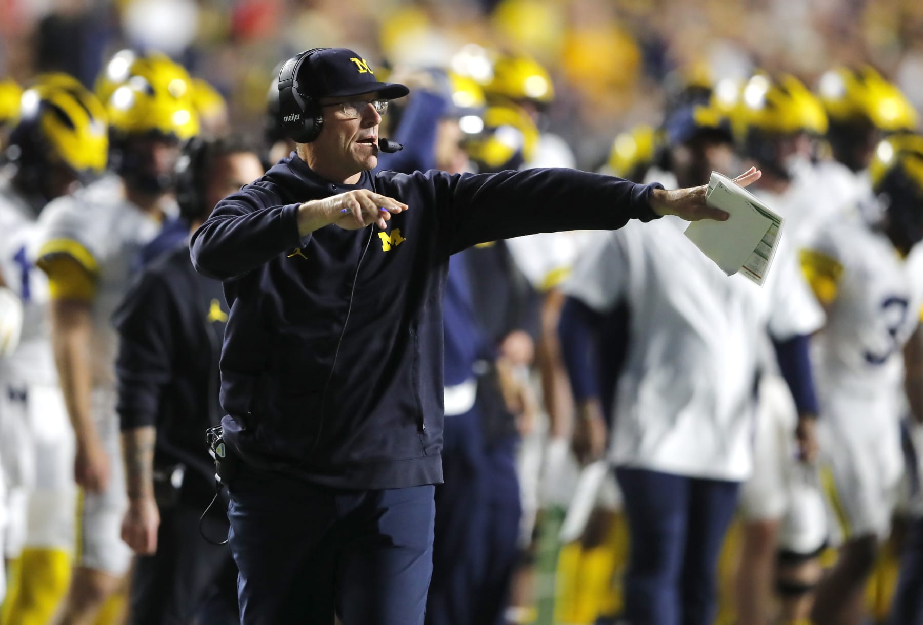 Michigan head coach Jim Harbaugh instructs his team against Rutgers during the first half of an NCAA college football game, Saturday, Nov. 5, 2022 in Piscataway, N.J. (AP Photo/Noah K. Murray)
