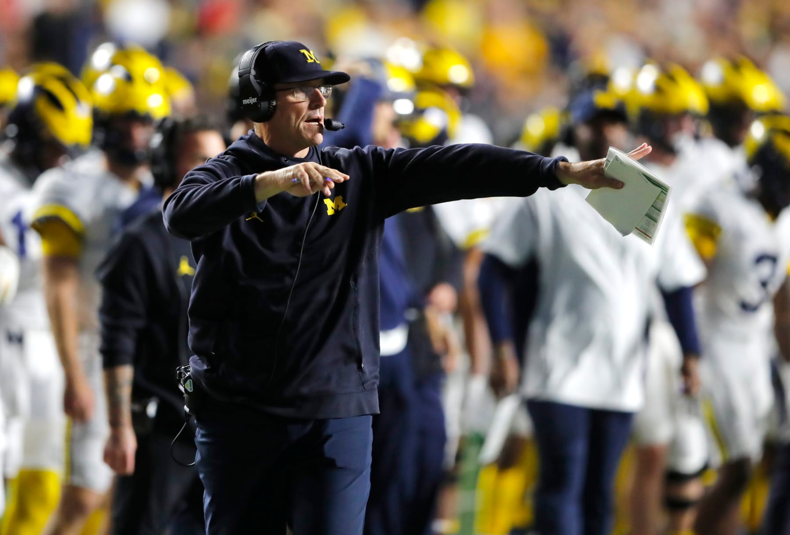Michigan head coach Jim Harbaugh instructs his team against Rutgers during the first half of an NCAA college football game, Saturday, Nov. 5, 2022 in Piscataway, N.J. (AP Photo/Noah K. Murray)