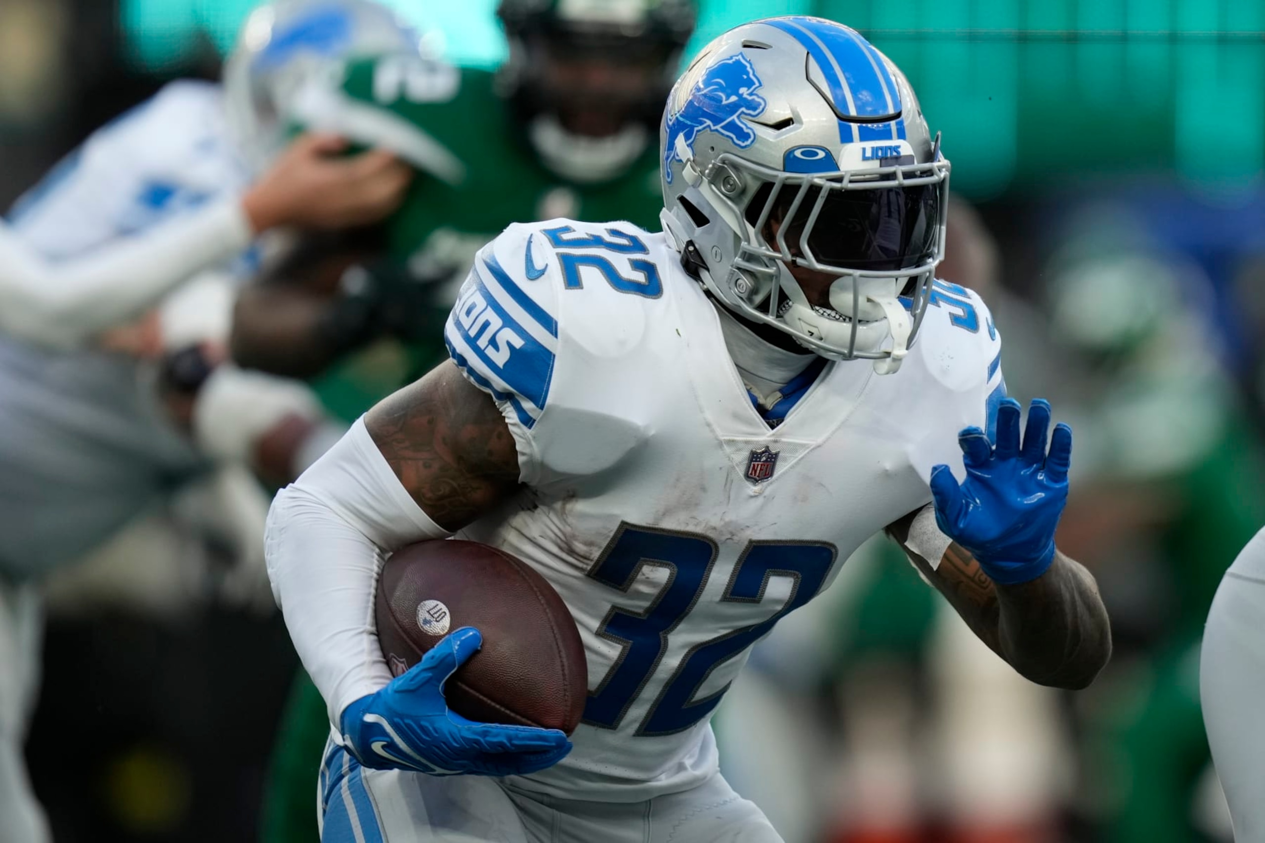 Detroit Lions running back D'Andre Swift (32) carries the ball against the New York Jets during the third quarter of an NFL football game, Sunday, Dec. 18, 2022, in East Rutherford, N.J. (AP Photo/Seth Wenig)