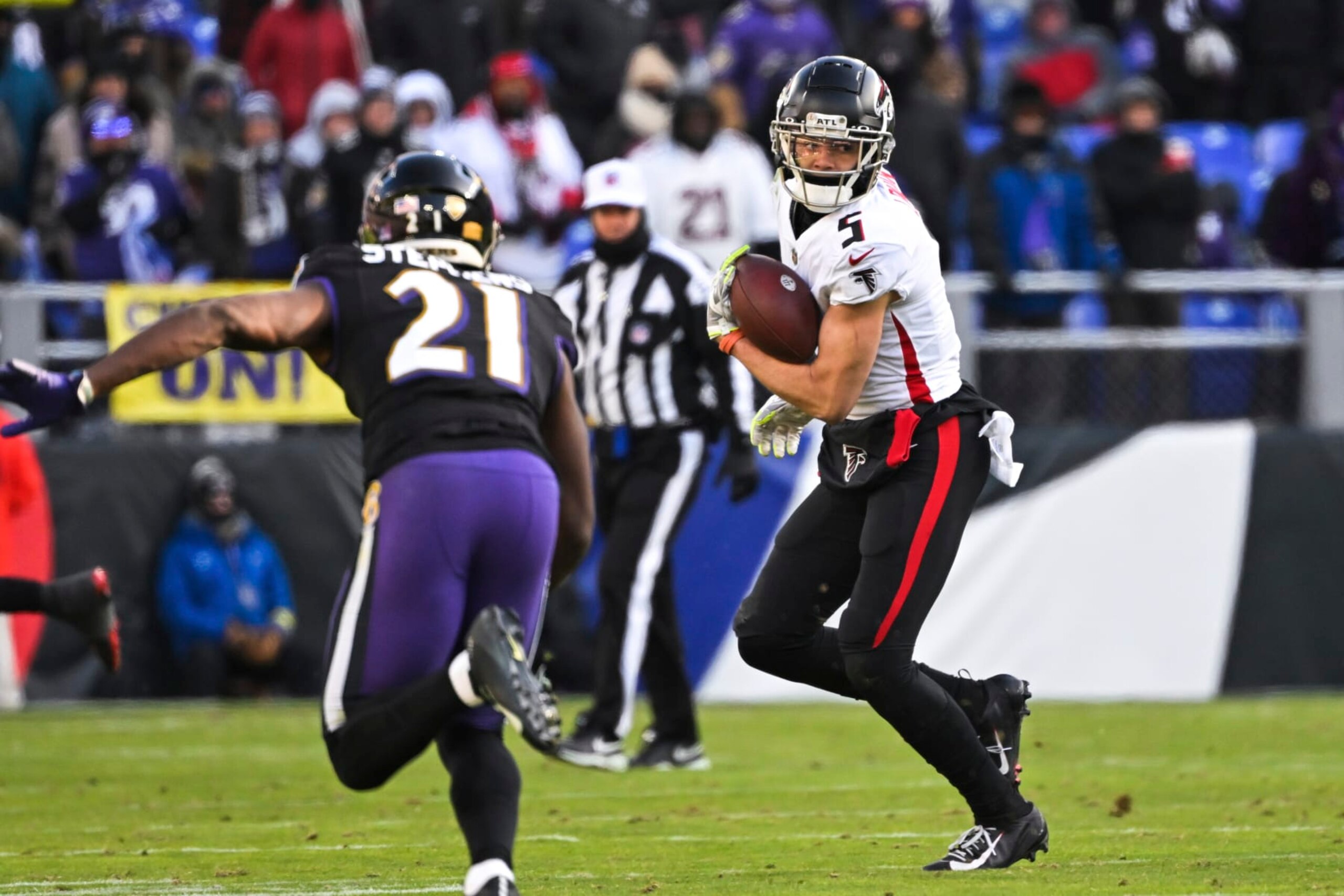 Atlanta Falcons wide receiver Drake London (5) runs with the ball after making a catch against Baltimore Ravens cornerback Brandon Stephens (21) during the first half of an NFL football game, Saturday, Dec. 24, 2022, in Baltimore. (AP Photo/Terrance Williams)