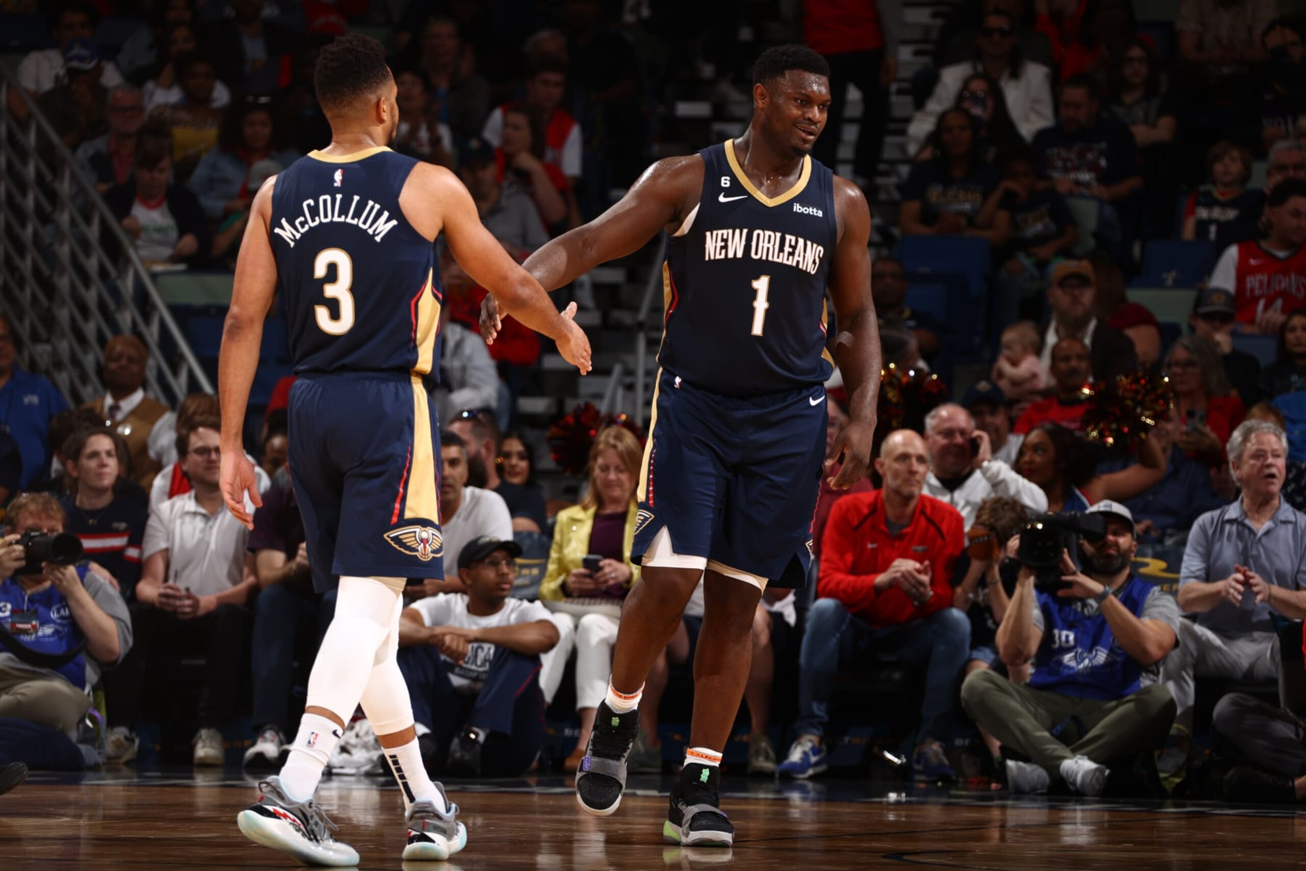 NEW ORLEANS, LA - DECEMBER 4: CJ McCollum #3 of the New Orleans Pelicans high-fives teammate Zion Williamson #1 during the game against the Denver Nuggets on December 4, 2022 at the Smoothie King Center in New Orleans, Louisiana. NOTE TO USER: User expressly acknowledges and agrees that, by downloading and or using this Photograph, user is consenting to the terms and conditions of the Getty Images License Agreement. Mandatory Copyright Notice: Copyright 2022 NBAE (Photo by Ned Dishman/NBAE via Getty Images) NEW ORLEANS, LA - DECEMBER 4: CJ McCollum #3 of the New Orleans Pelicans high-fives teammate Zion Williamson #1 during the game against the Denver Nuggets on December 4, 2022 at the Smoothie King Center in New Orleans, Louisiana. NOTE TO USER: User expressly acknowledges and agrees that, by downloading and or using this Photograph, user is consenting to the terms and conditions of the Getty Images License Agreement. Mandatory Copyright Notice: Copyright 2022 NBAE (Photo by Ned Dishman/NBAE via Getty Images)