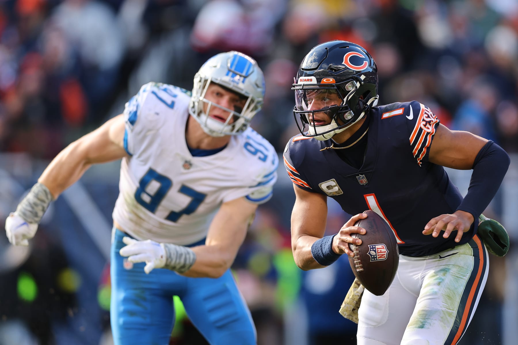 CHICAGO, ILLINOIS - NOVEMBER 13: Justin Fields #1 of the Chicago Bears runs with the ball against the Detroit Lions at Soldier Field on November 13, 2022 in Chicago, Illinois. (Photo by Michael Reaves/Getty Images)