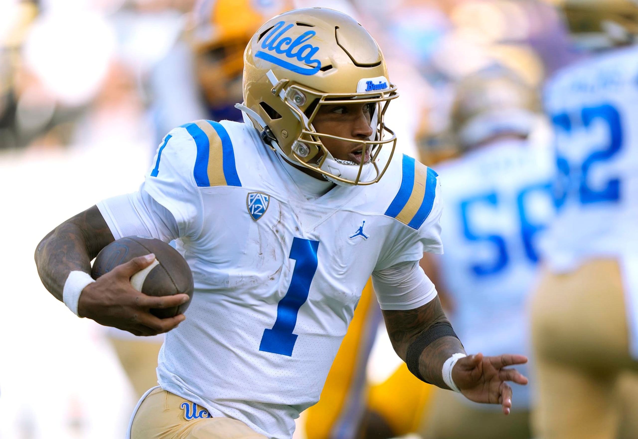 BERKELEY, CALIFORNIA - NOVEMBER 25: Dorian Thompson-Robinson #1 of the UCLA Bruins scrambles with the ball against the California Golden Bears during the second quarter of an NCAA football game at California Memorial Stadium on November 25, 2022 in Berkeley, California. (Photo by Thearon W. Henderson/Getty Images)