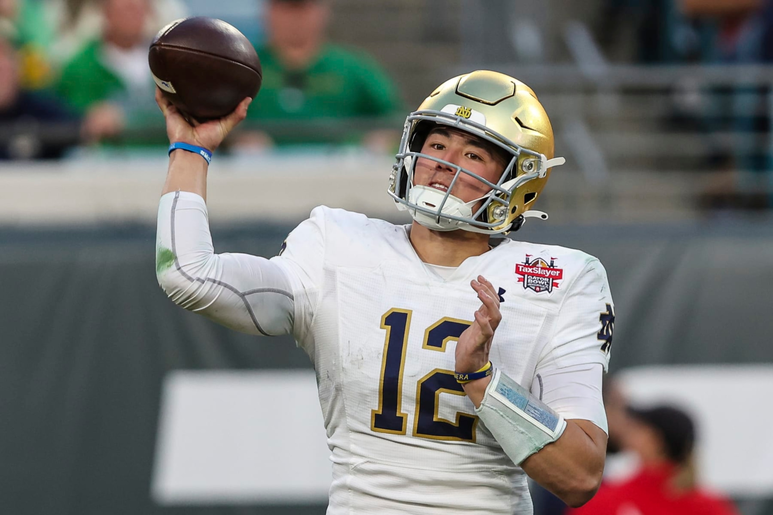 Notre Dame quarterback Tyler Buchner (12) throws a pass during the second quarter of the Gator Bowl NCAA college football game against South Carolina on Friday, Dec. 30, 2022, in Jacksonville, Fla. (AP Photo/Gary McCullough)